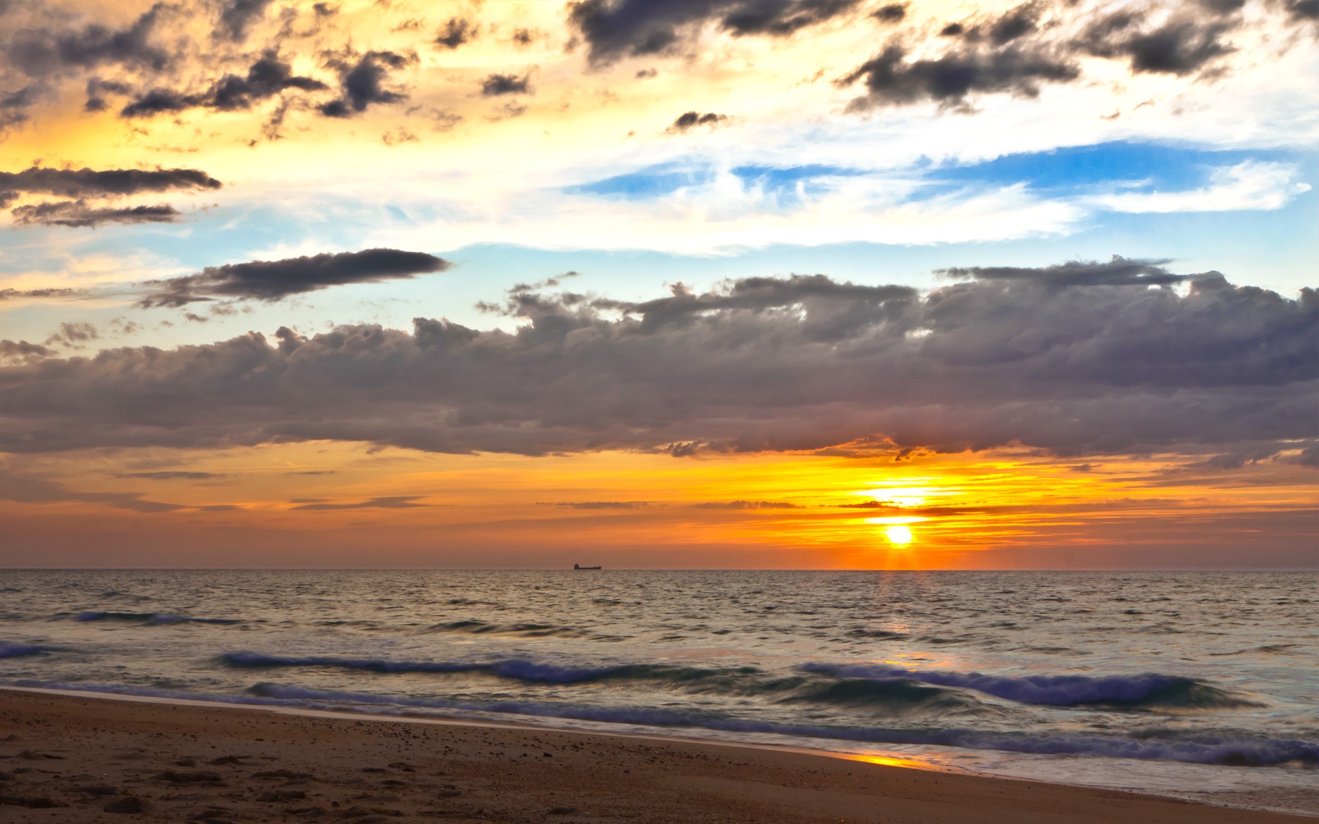 Sunset over the ocean with clouds and a ship HD Wallpaper