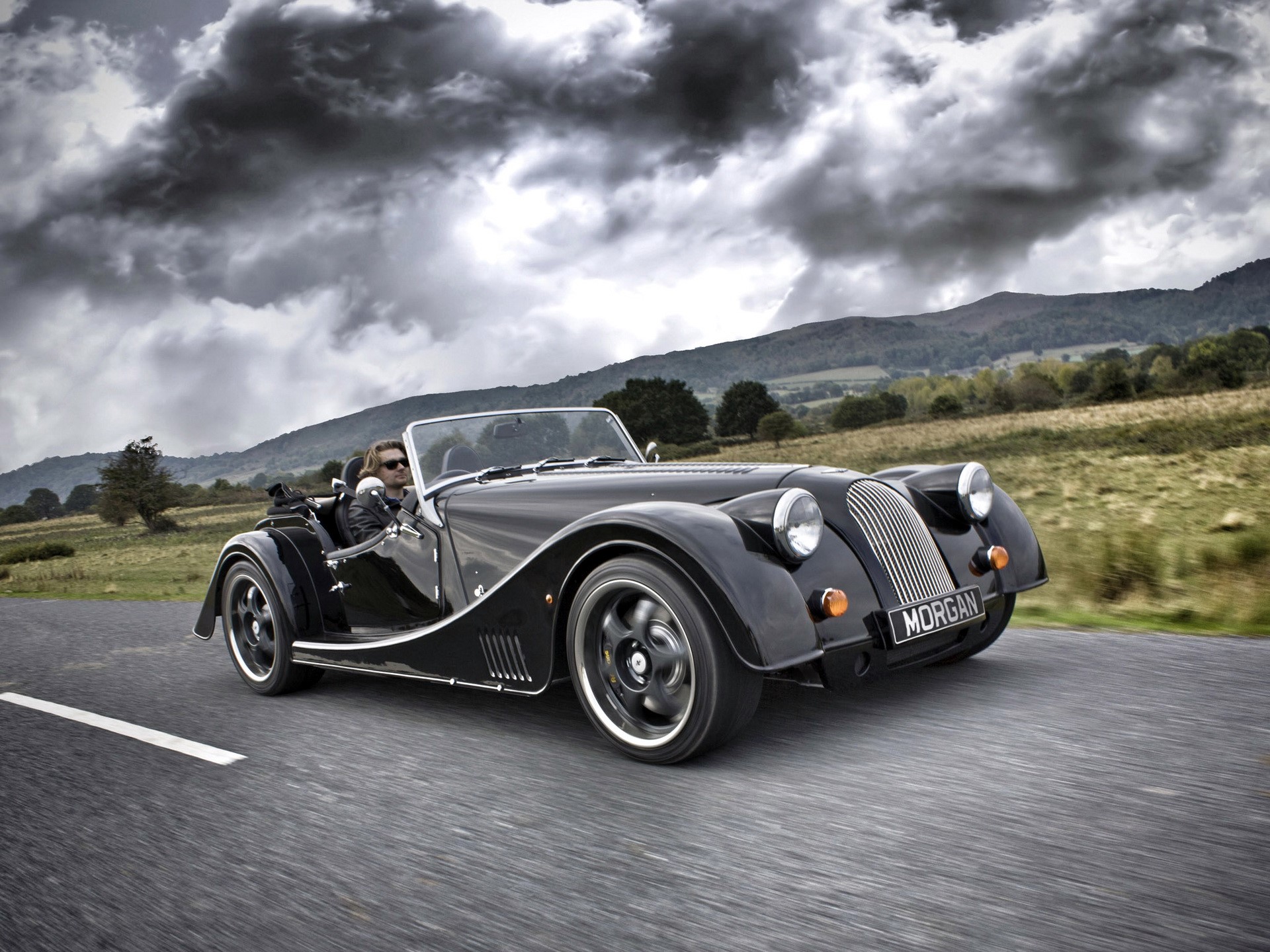 Black Morgan Plus 8 driving on a road HD Wallpaper