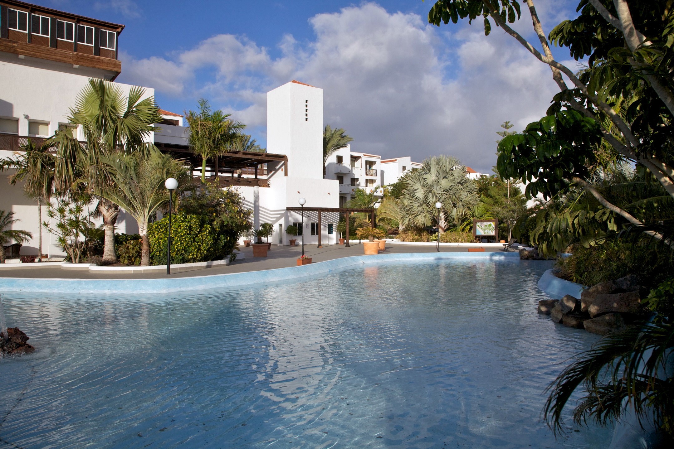 Resort with swimming pool and palm trees HD Wallpaper