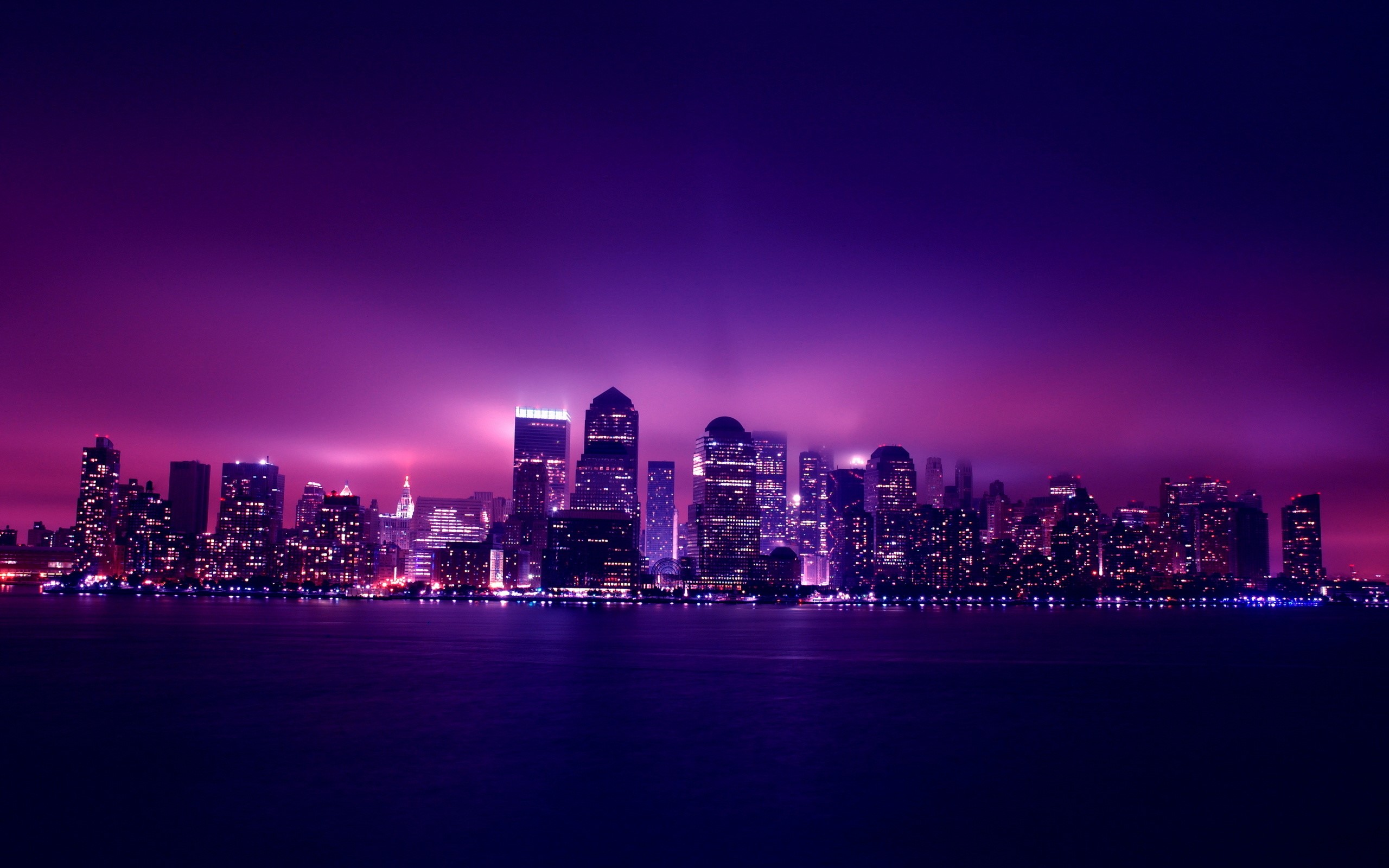 New York City skyline at night with purple sky HD Wallpaper