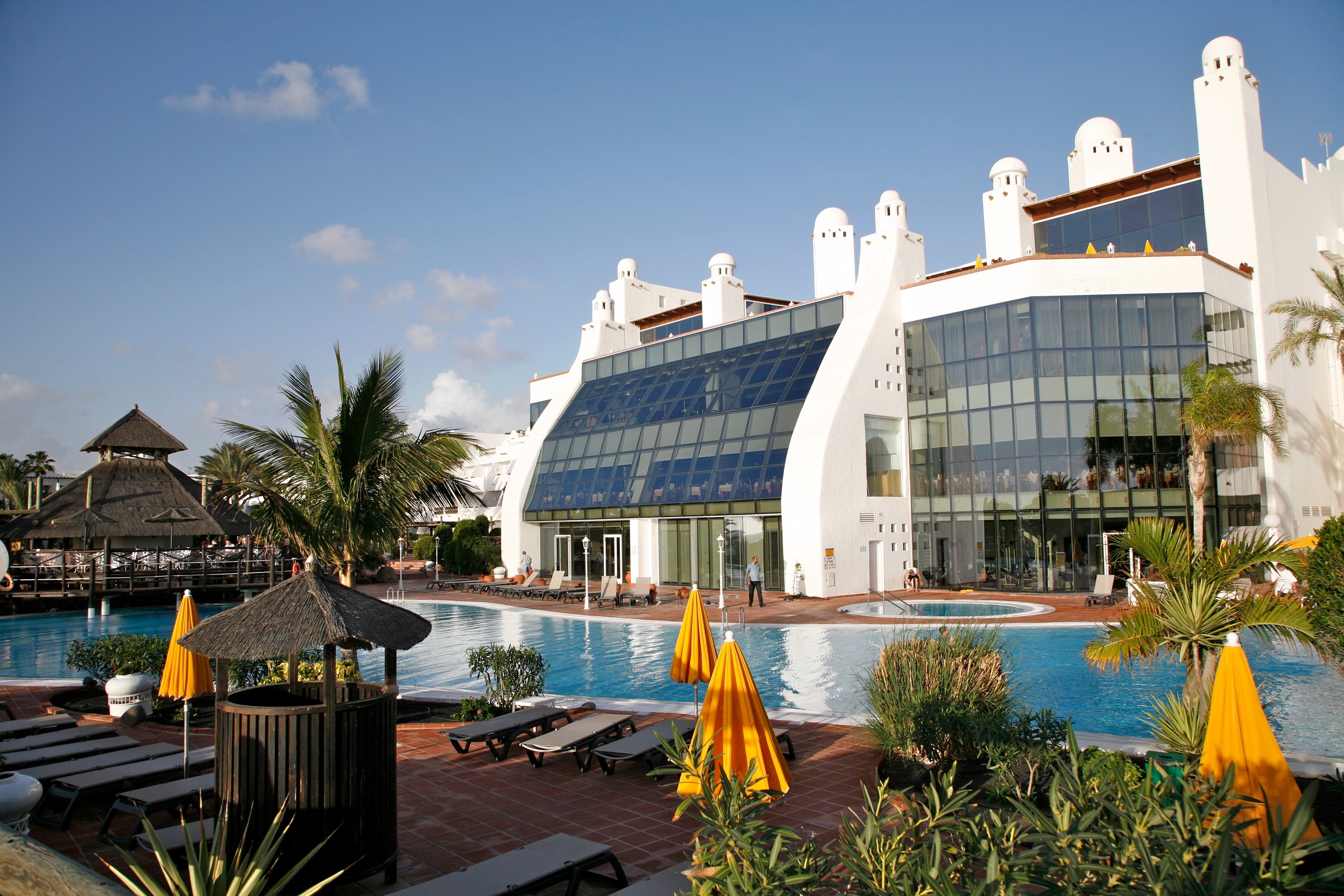 Resort with swimming pools and palm trees HD Wallpaper