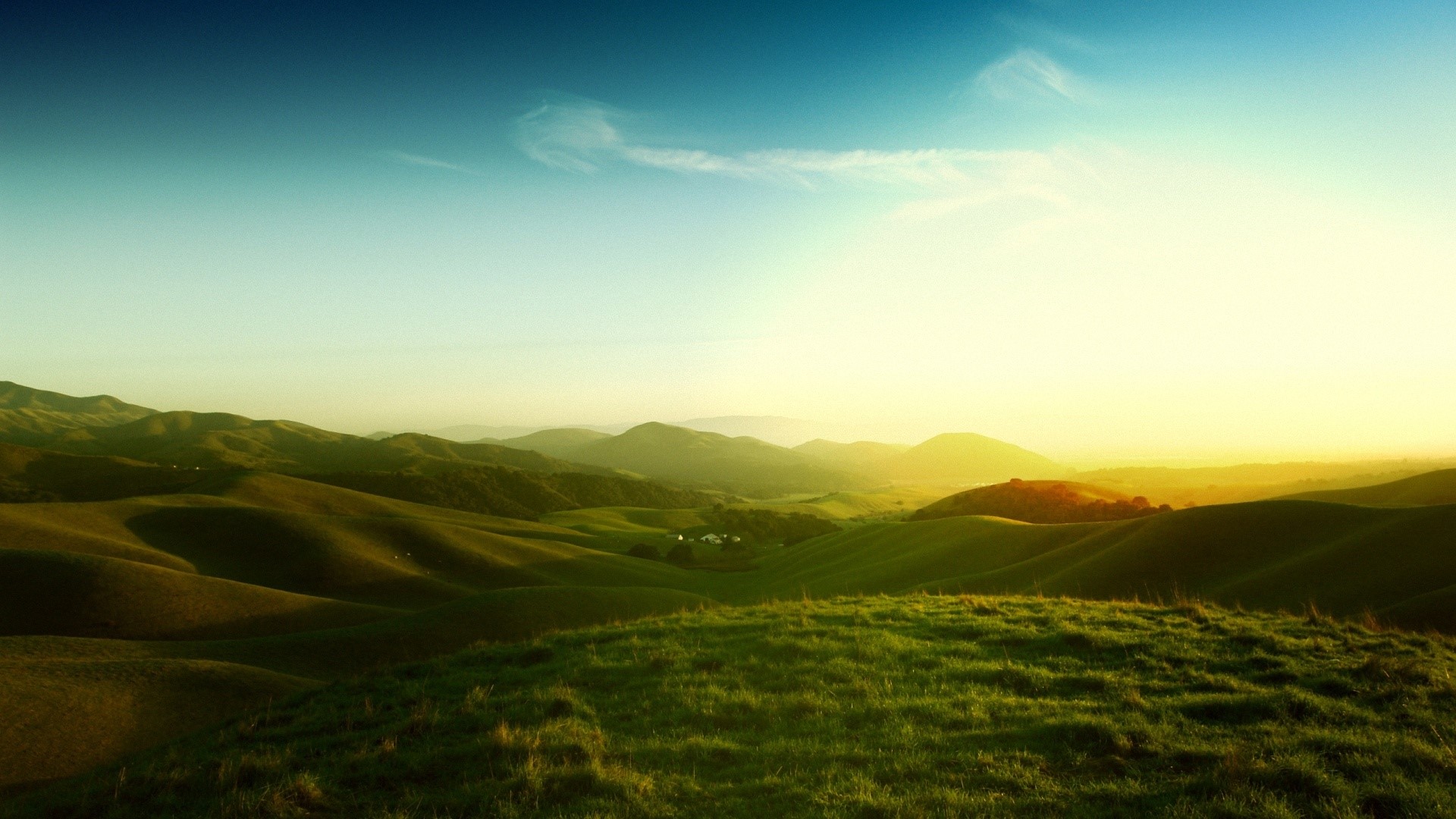 Rolling green hills under a bright sky HD Wallpaper