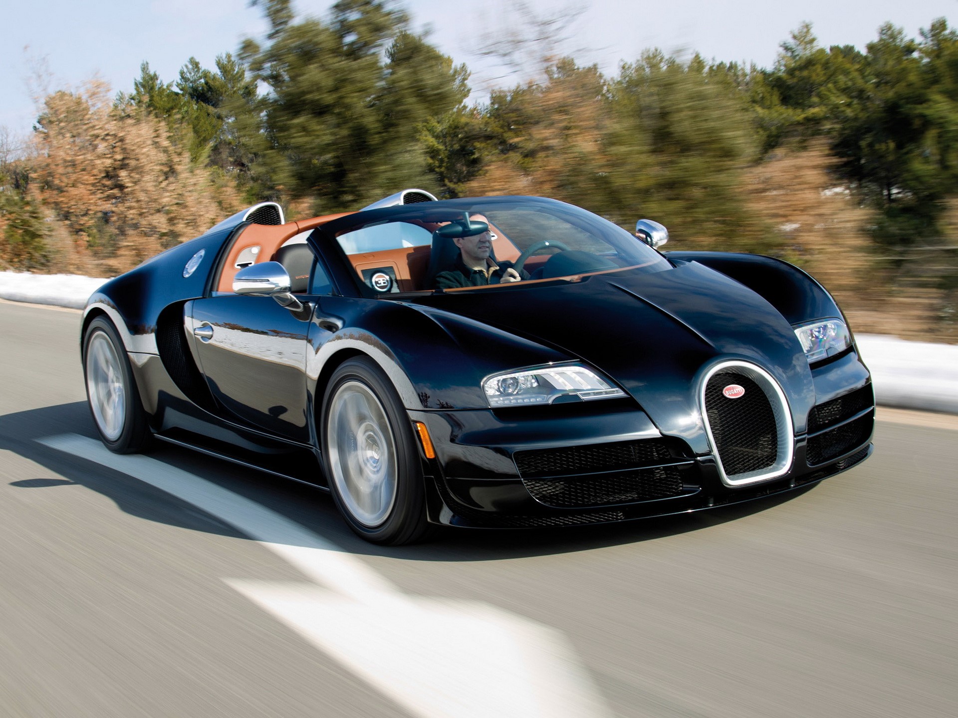 Black Bugatti Veyron Grand Sport driving on a road HD Wallpaper