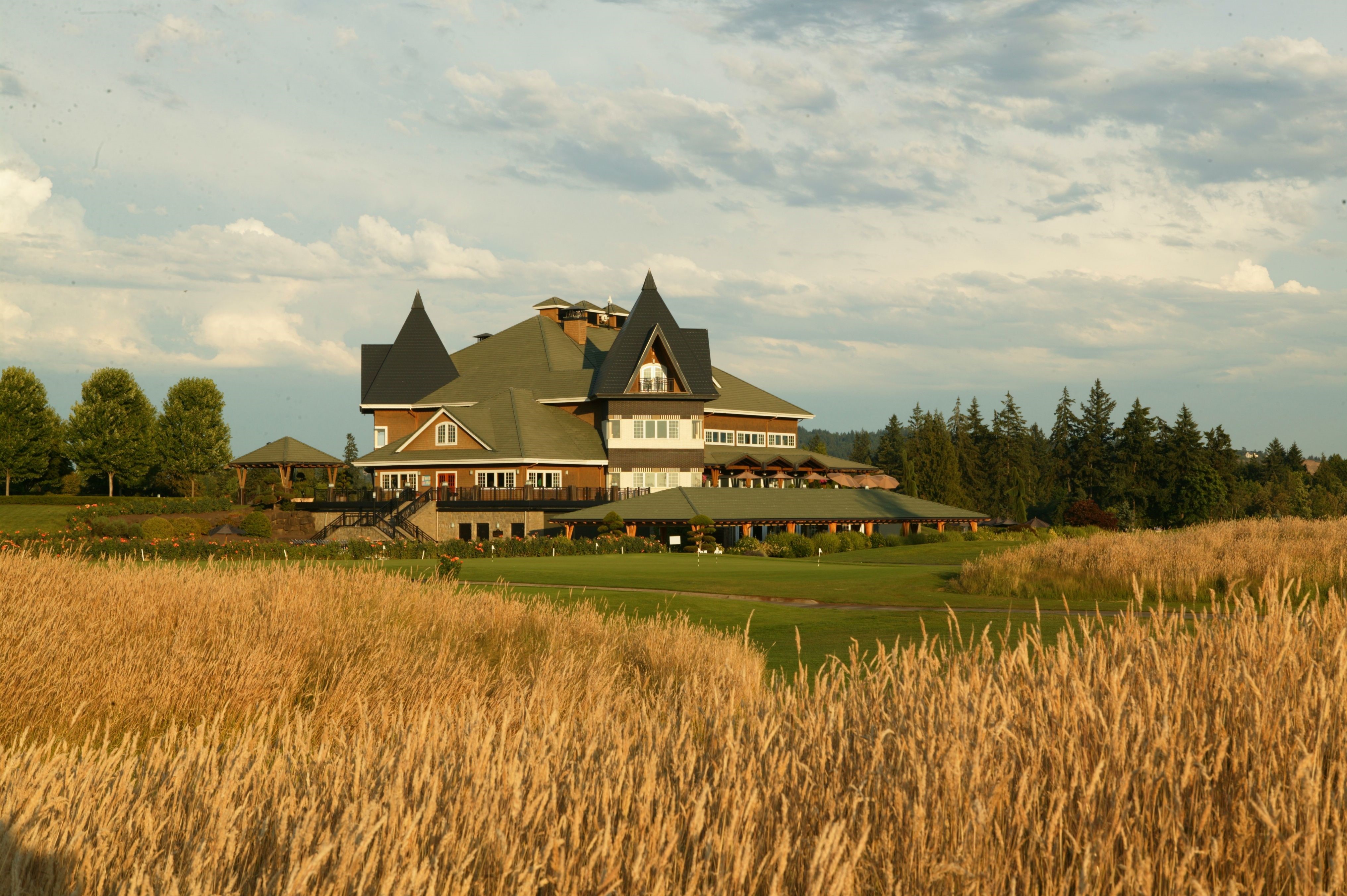 Large building on a golf course with tall grass HD Wallpaper