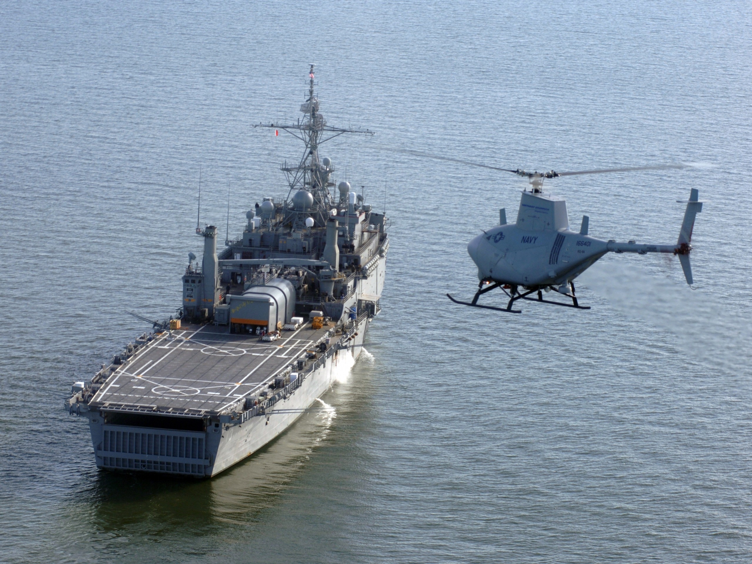 Unmanned helicopter flies near a Navy ship HD Wallpaper
