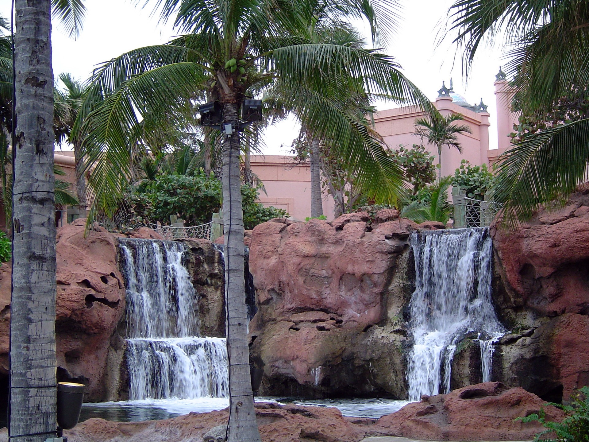 Waterfalls with Palm Trees and Pink Building HD Wallpaper