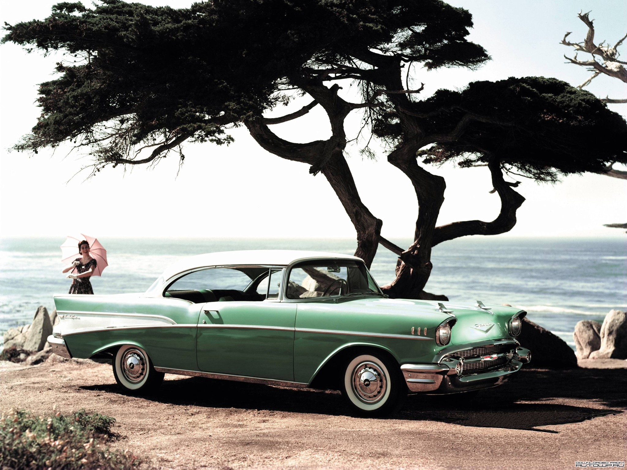 1957 Chevrolet Bel Air Sport Coupe with a woman holding an umbrella HD Wallpaper
