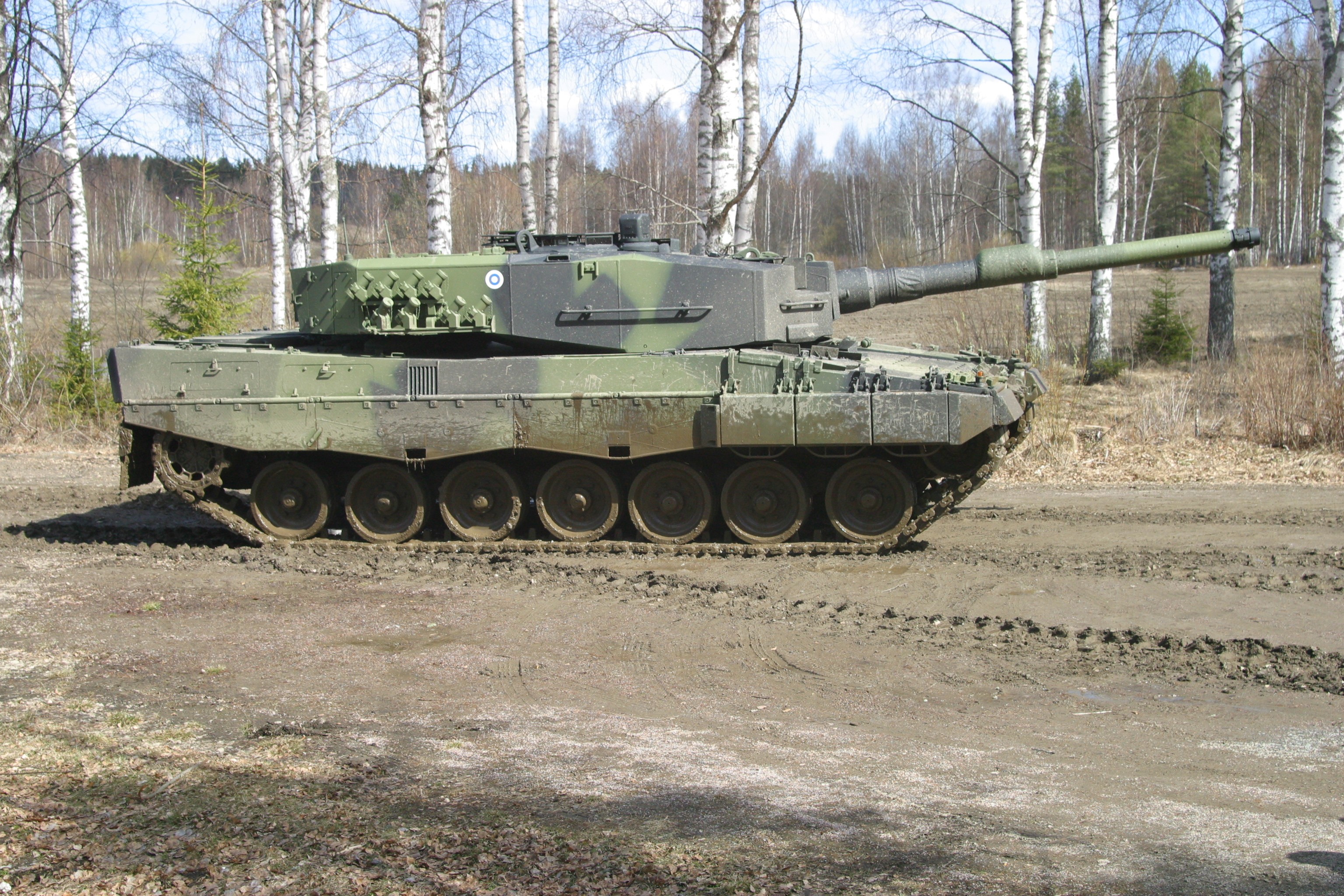 Leopard 2 tank in a forest setting HD Wallpaper