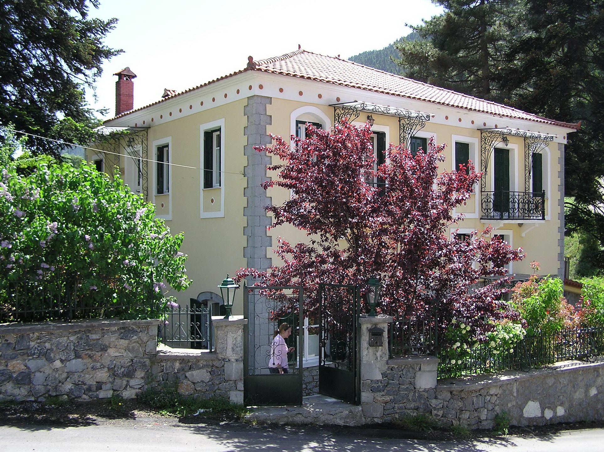 Yellow house with stone fence in Greece HD Wallpaper