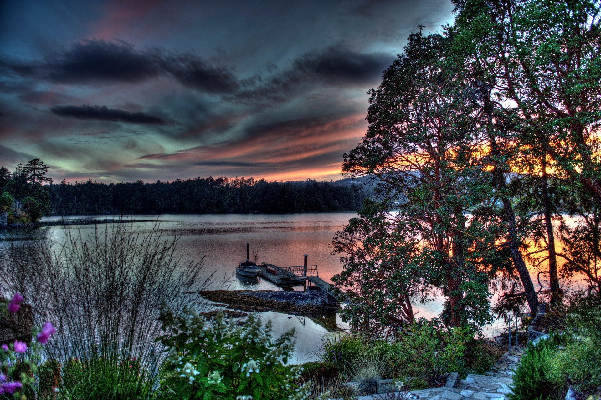 Sunset over a calm river with trees and a dock HD Wallpaper