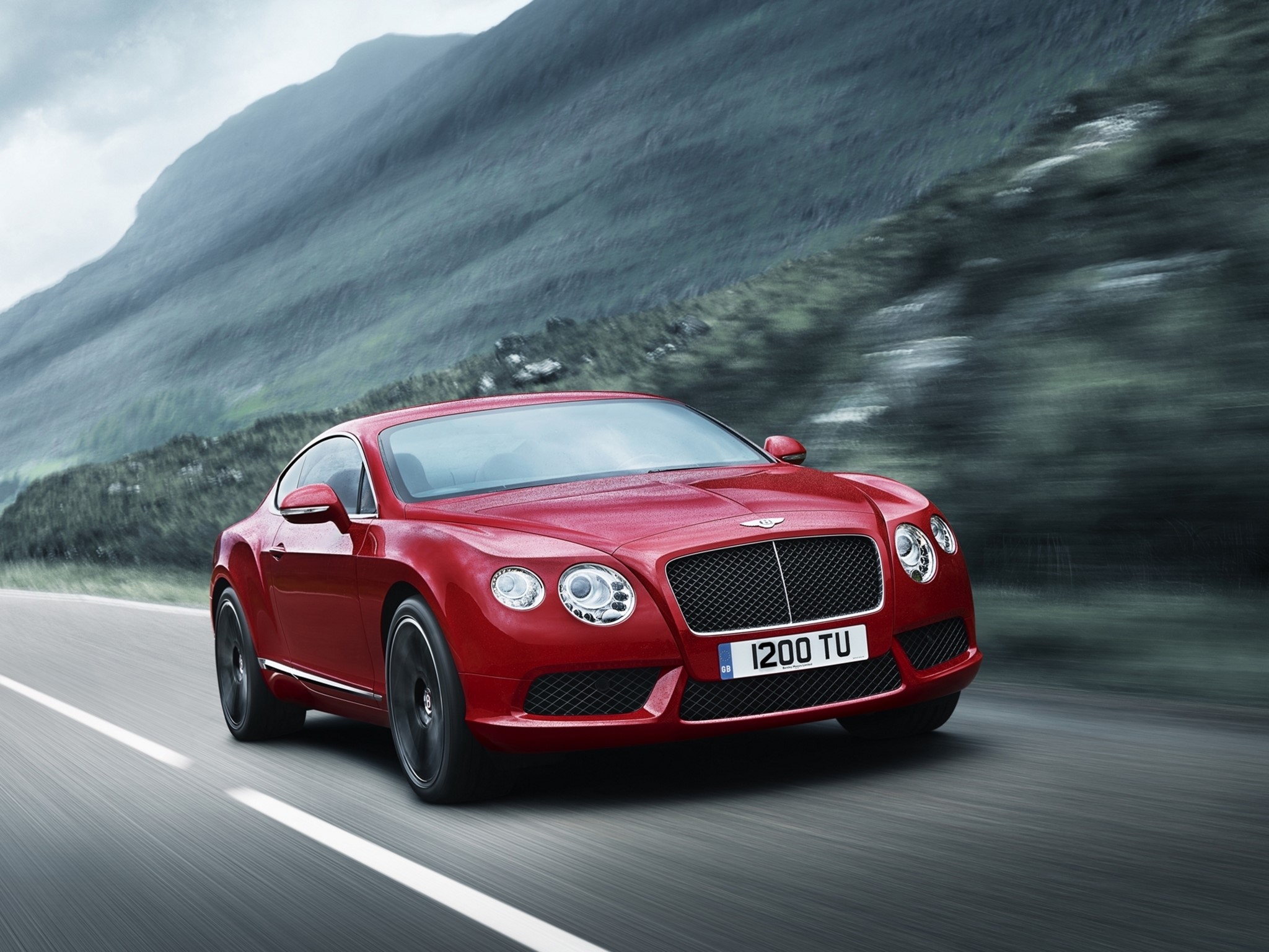 Red Bentley Continental GT driving on a road HD Wallpaper