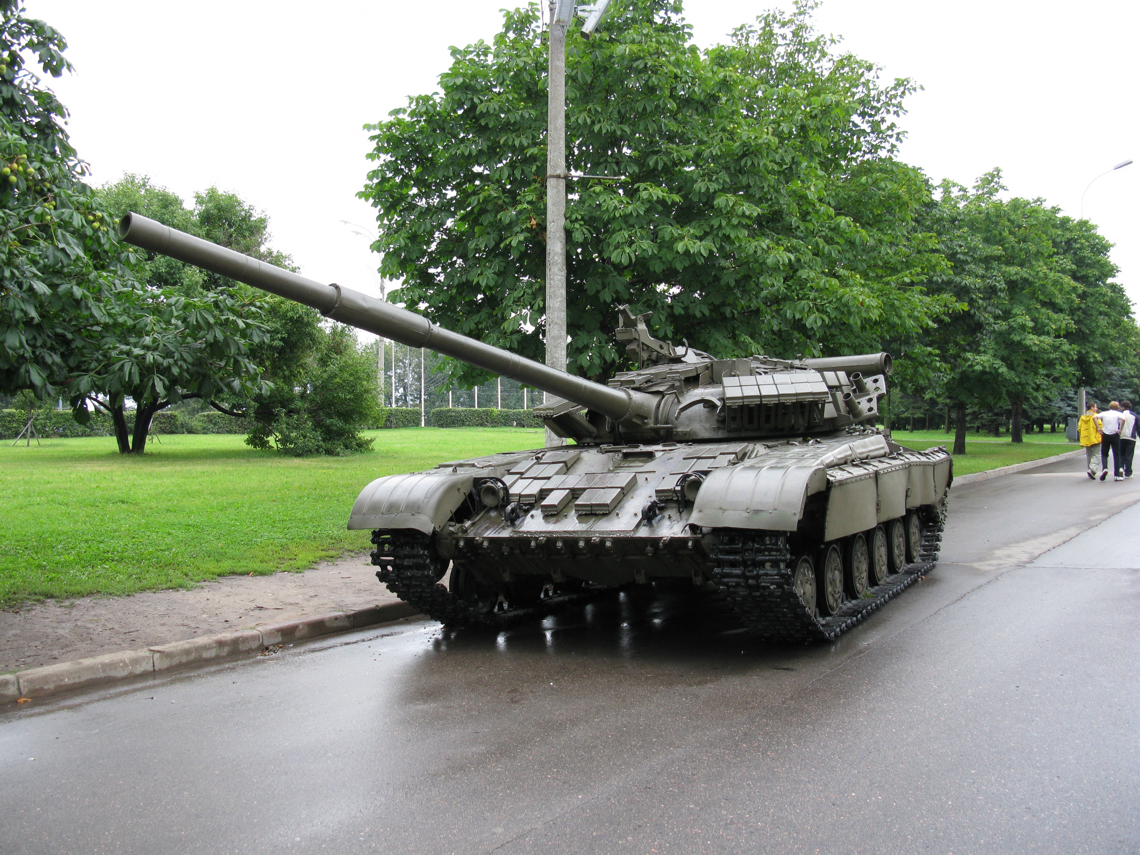 Tank on a wet road with trees HD Wallpaper