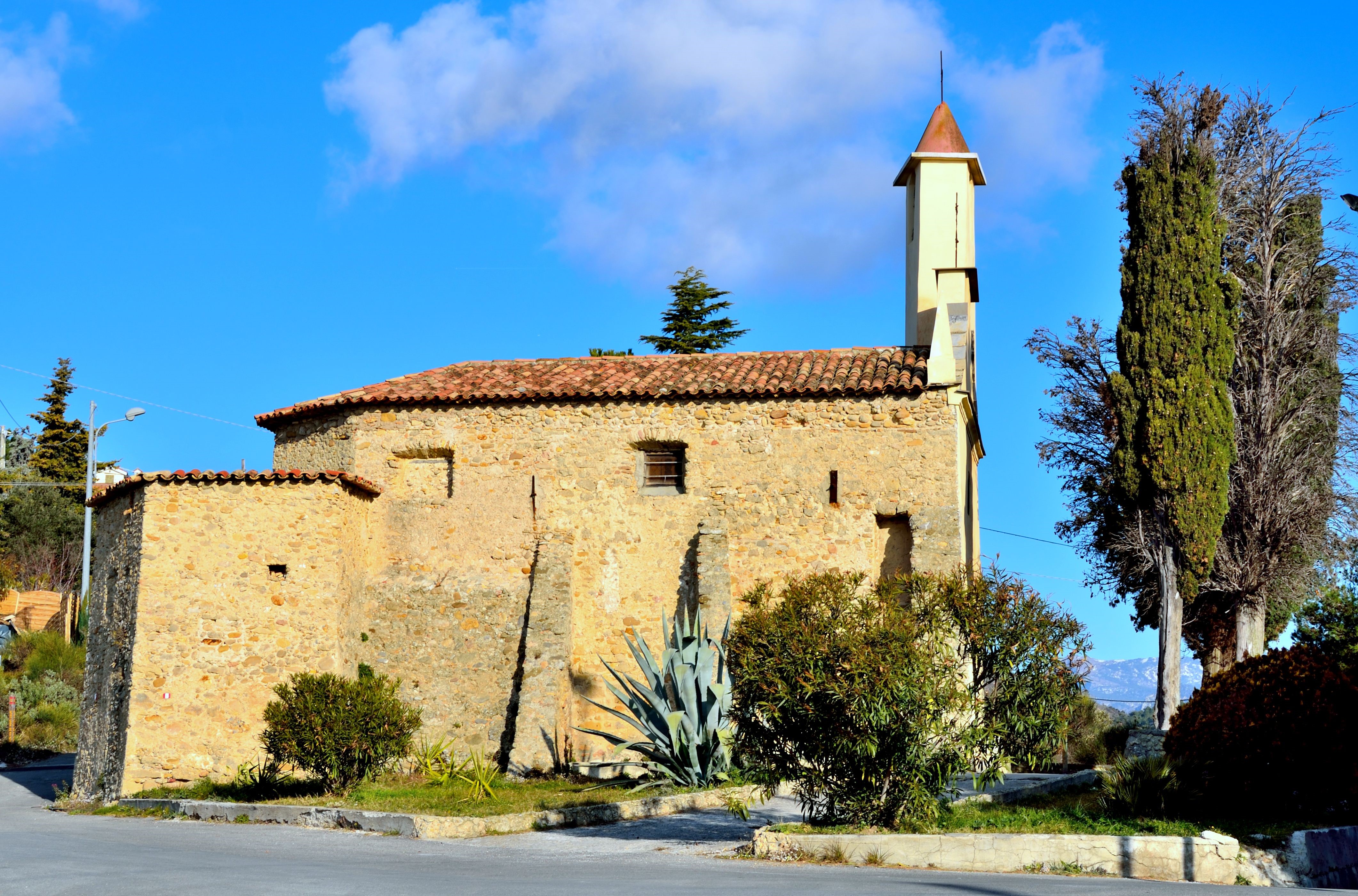 Stone building with bell tower and tiled roof HD Wallpaper