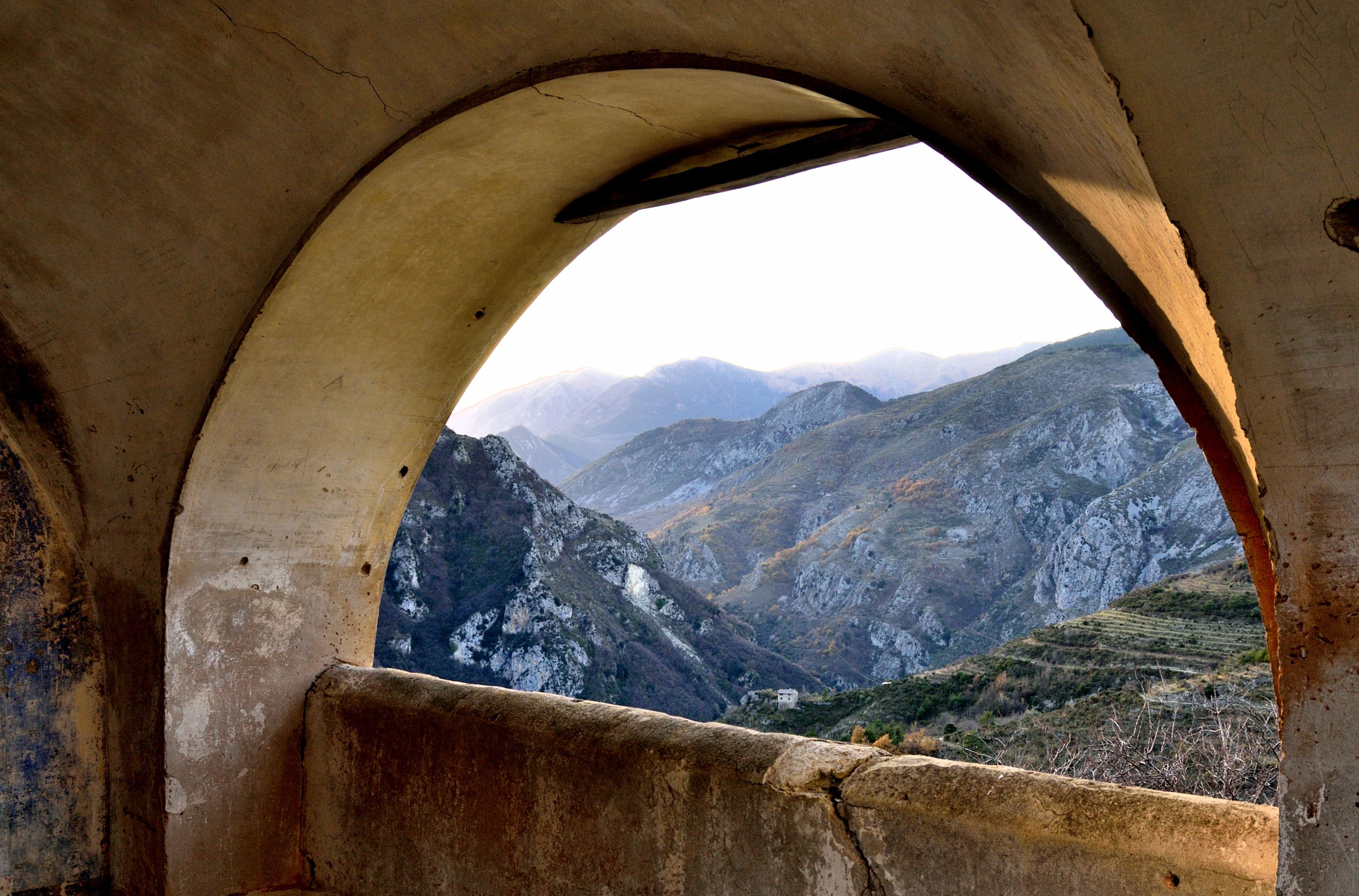 View of mountains through an arched opening HD Wallpaper