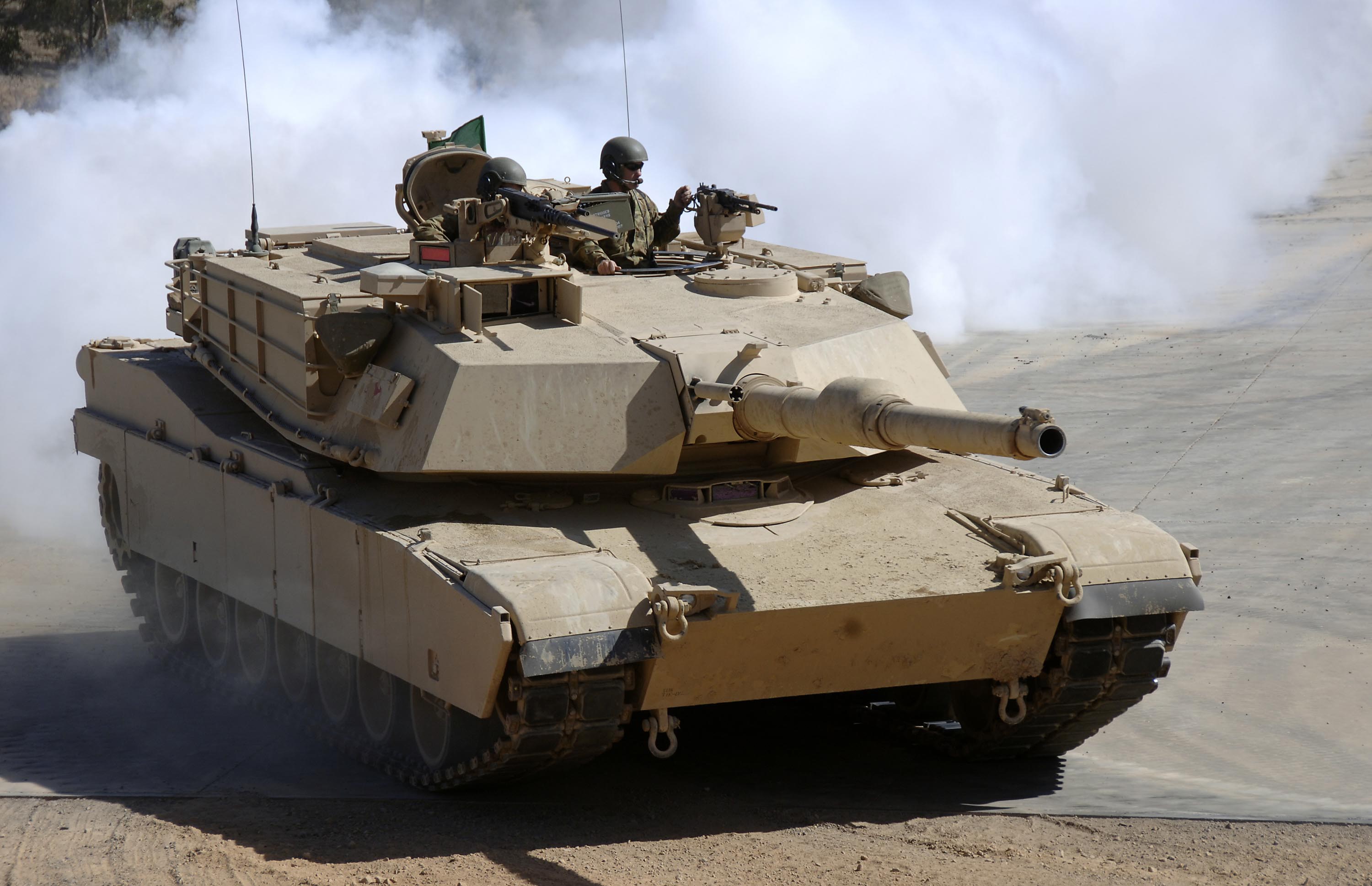 M1 Abrams tank with crew in smoke HD Wallpaper