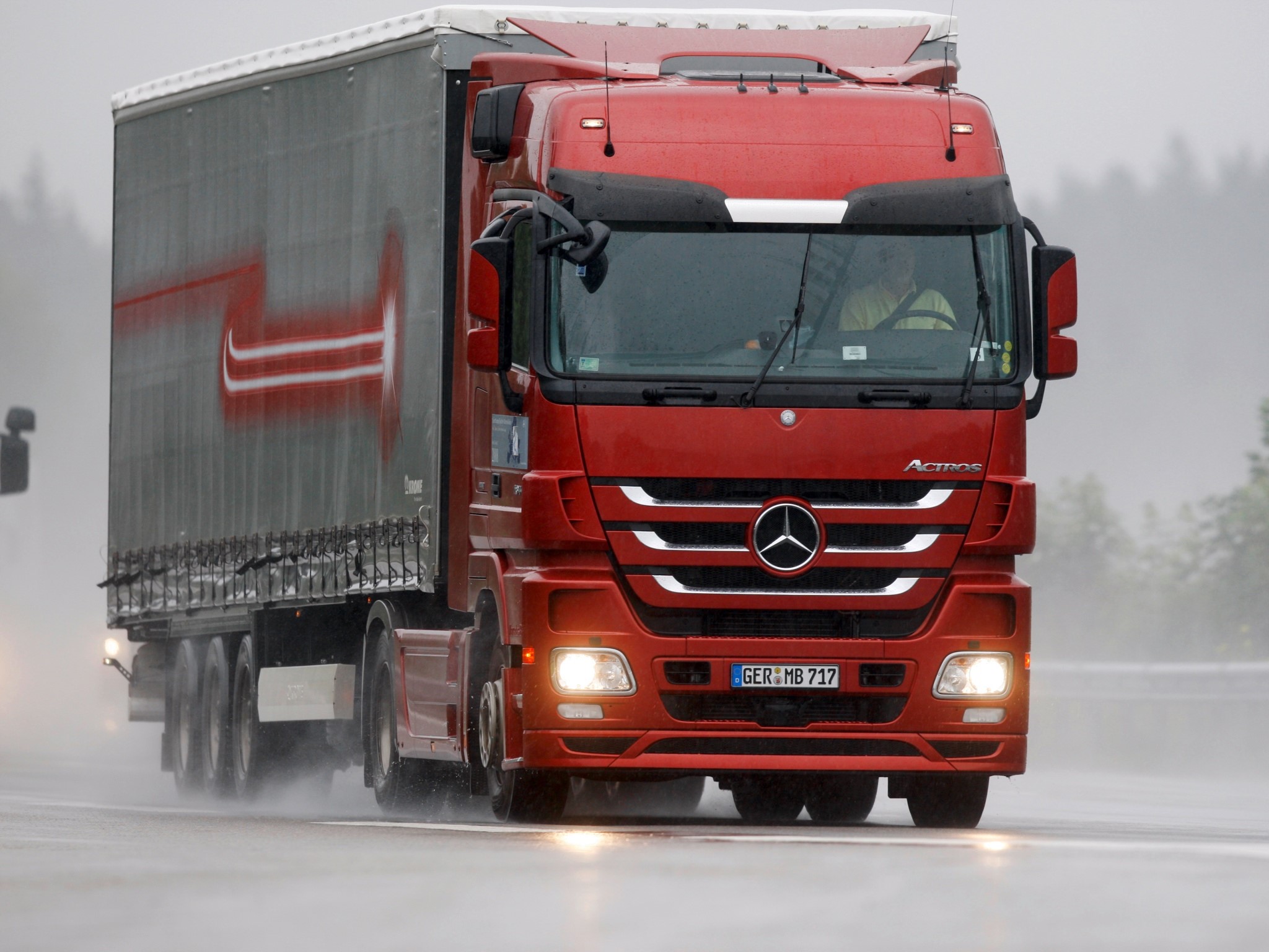 Red Mercedes-Benz Actros truck driving on a wet road HD Wallpaper