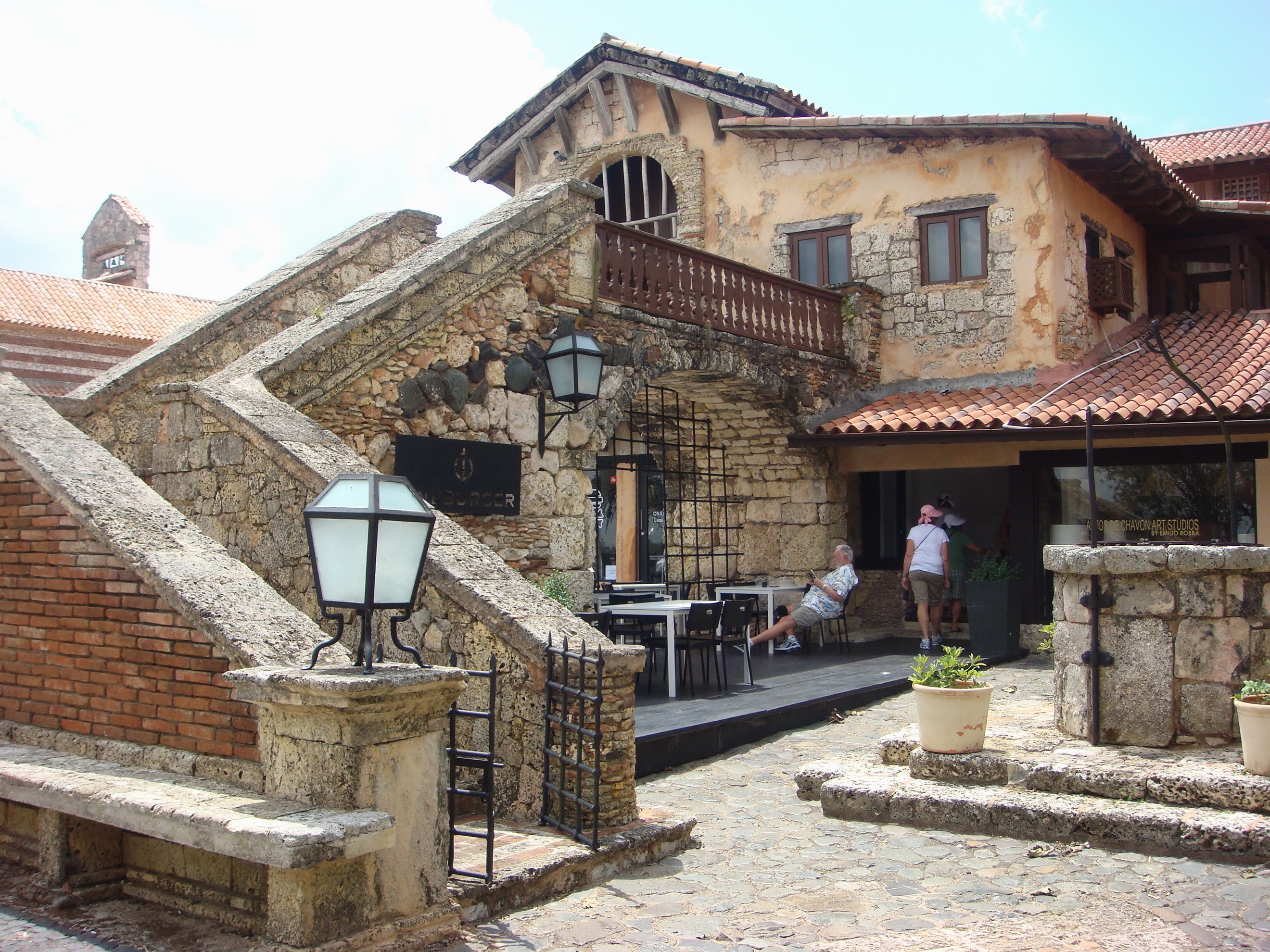 Stone building with outdoor seating and stairs HD Wallpaper