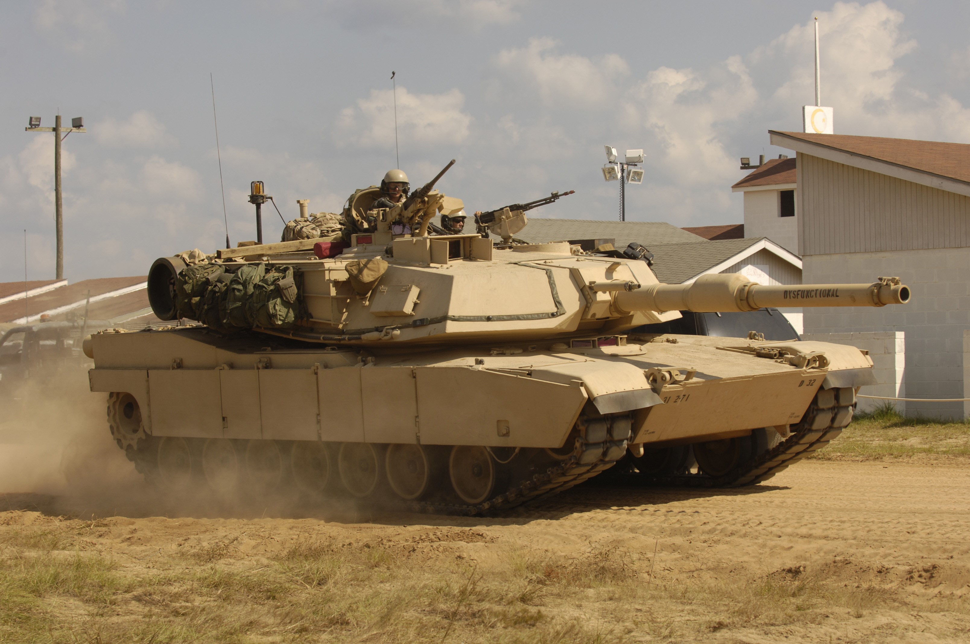 M1 Abrams tank with crew in desert environment HD Wallpaper