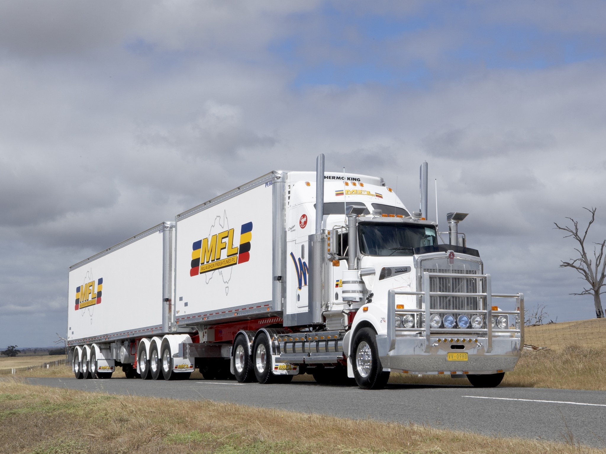 White Kenworth truck with MFL trailers on a road HD Wallpaper