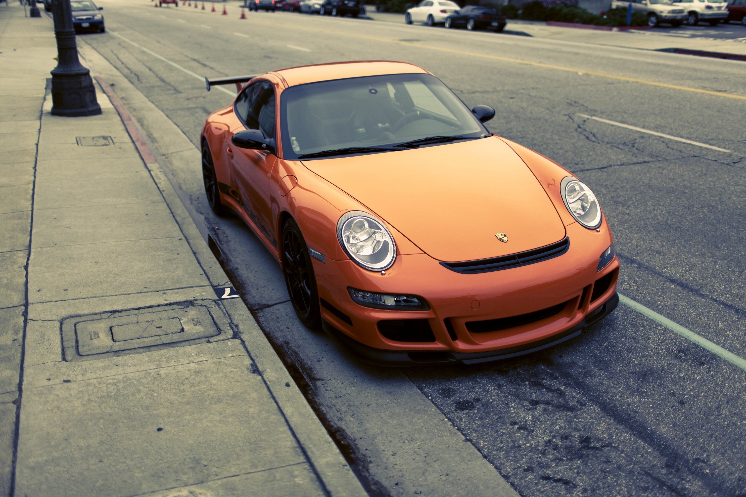 Orange Porsche 911 GT3 parked on a street HD Wallpaper