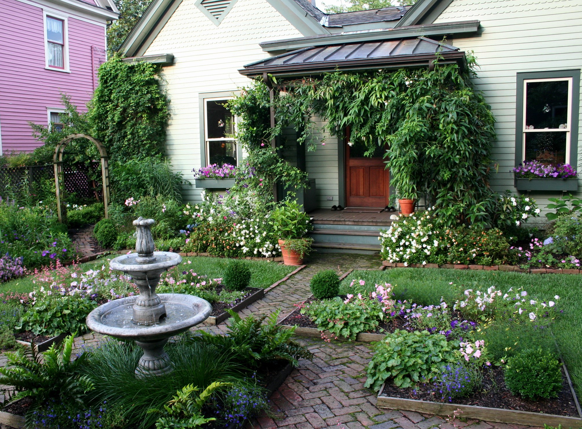 Front yard garden with fountain and porch HD Wallpaper
