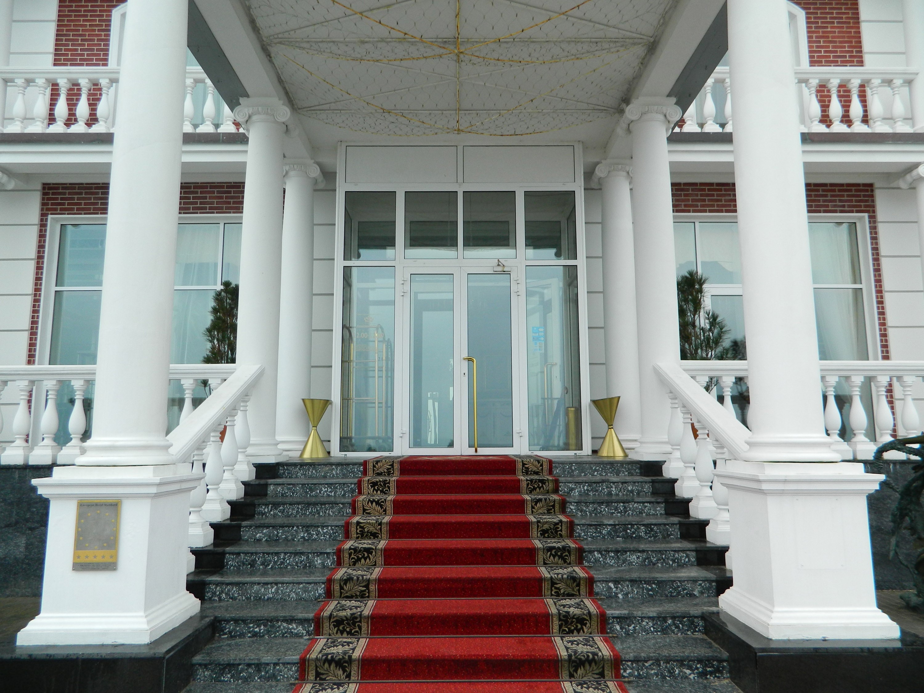 Hotel Grand Palace entrance with red carpet HD Wallpaper
