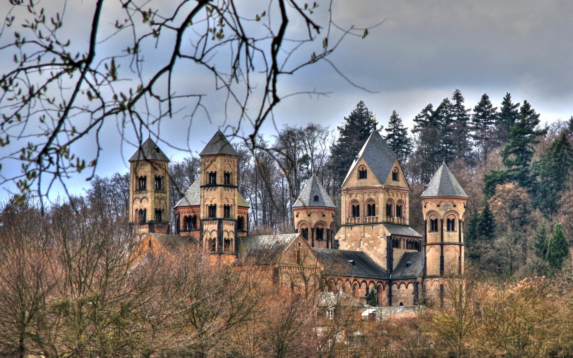Romanesque Abbey church with towers in a forest HD Wallpaper
