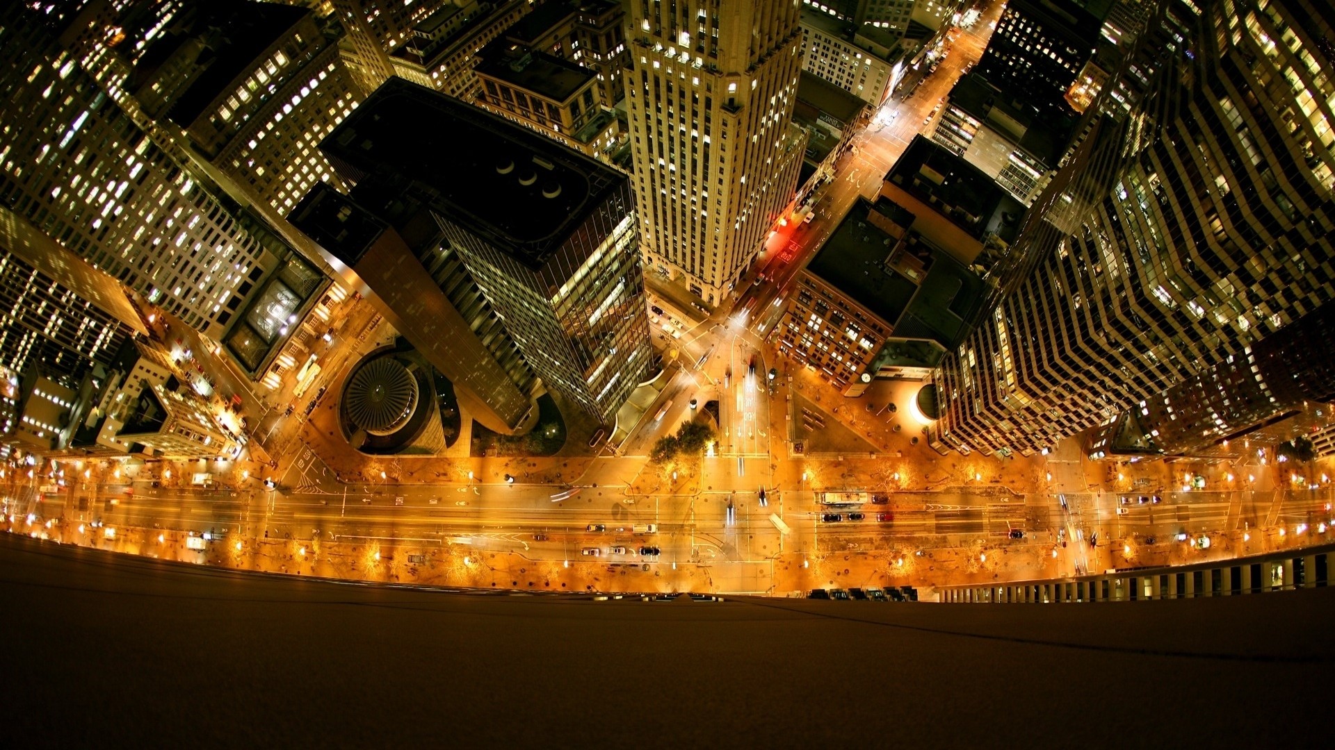 Aerial view of a city at night with illuminated skyscrapers HD Wallpaper