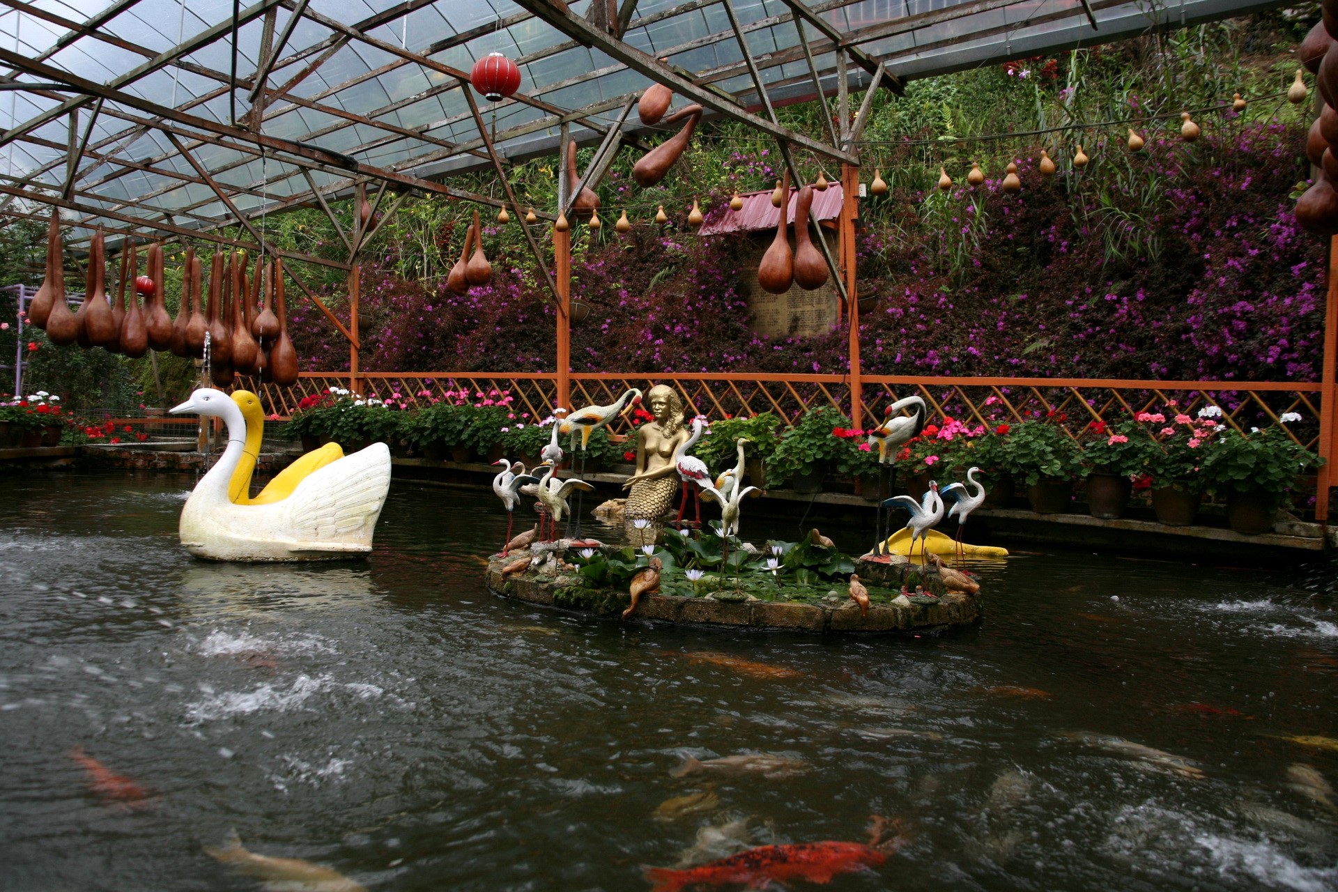 Garden pond with swan boat and mermaid statue HD Wallpaper