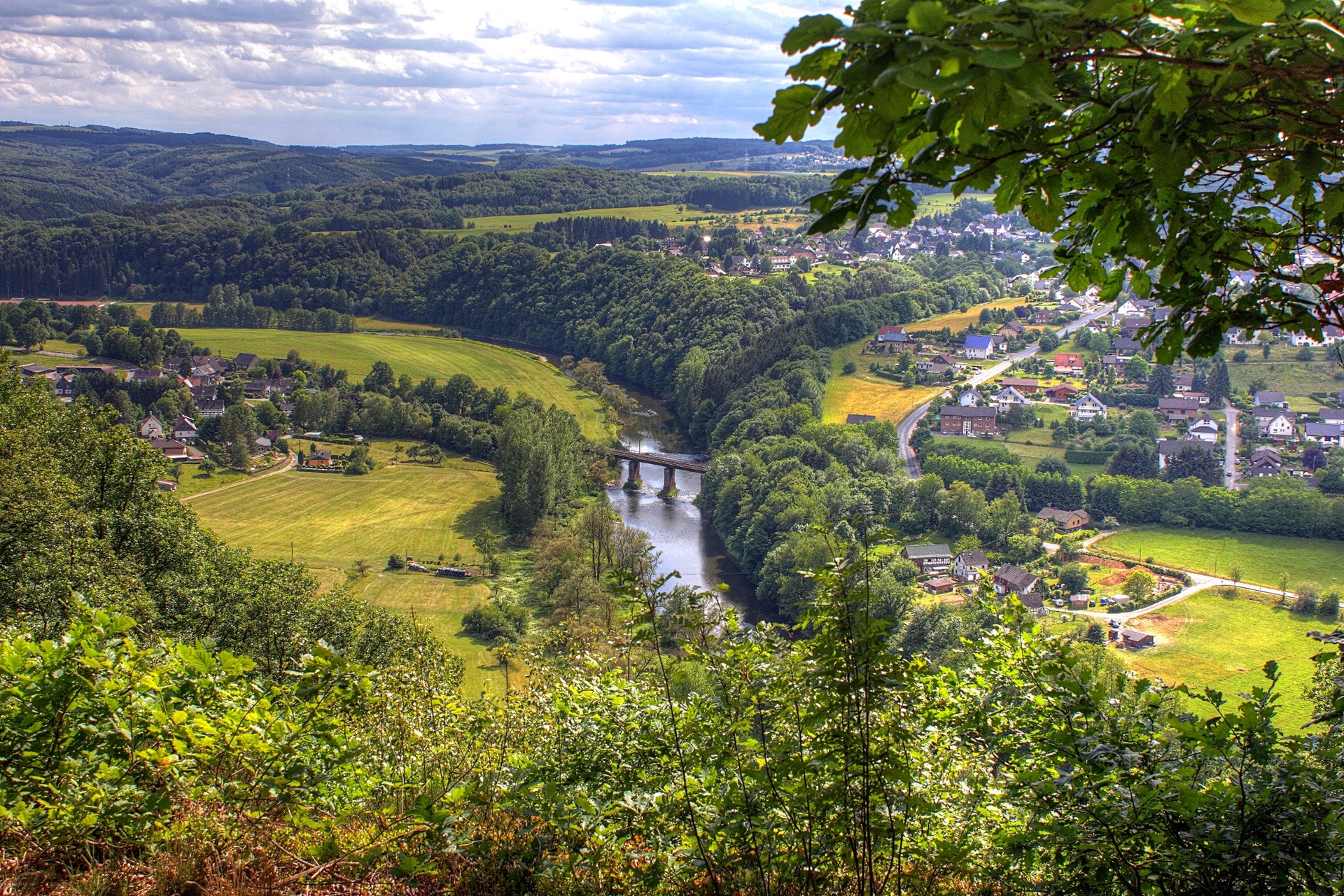 Aerial view of a German village nestled in a river valley HD Wallpaper