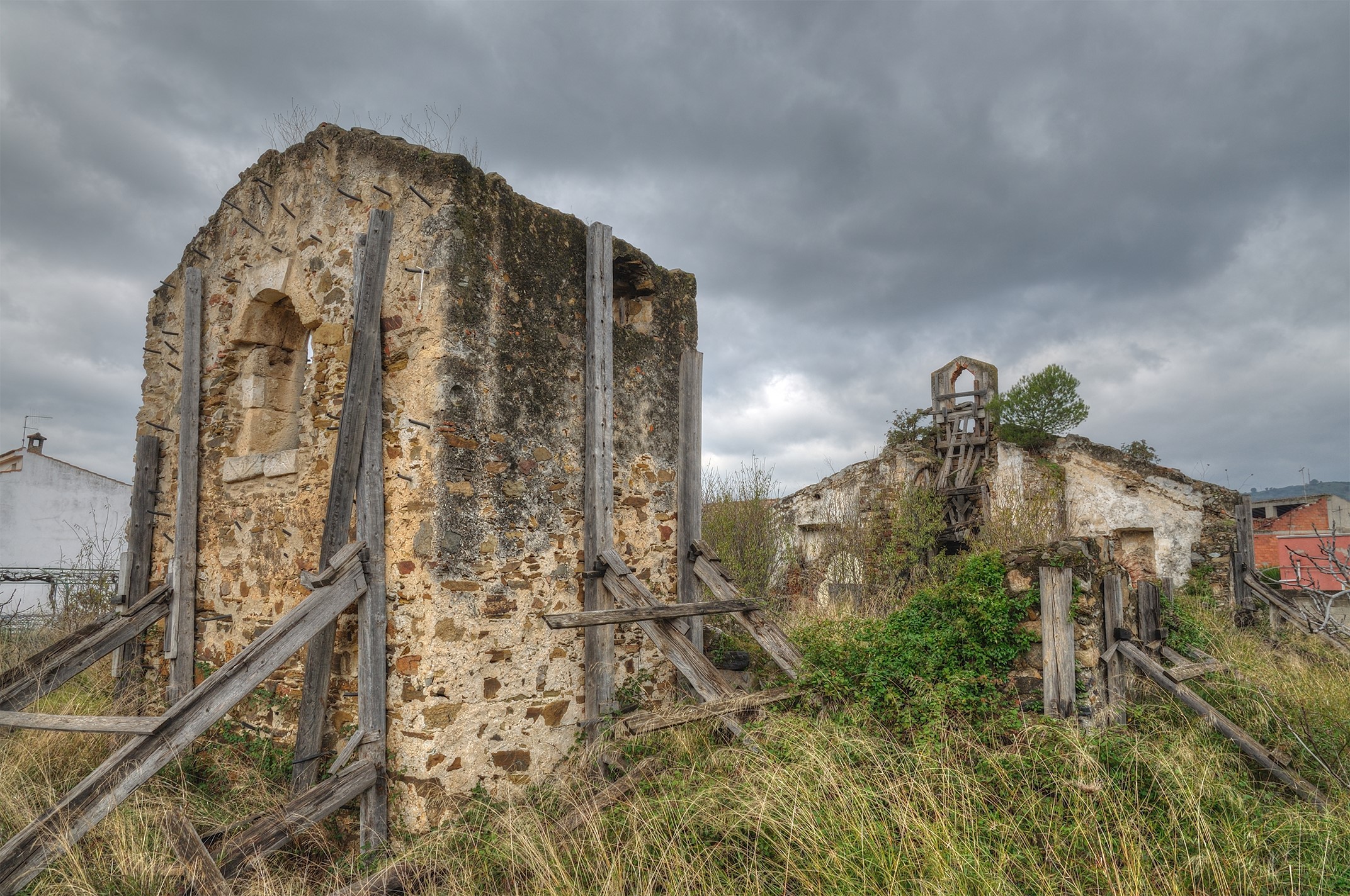 Ruins of an old stone building with wooden supports HD Wallpaper