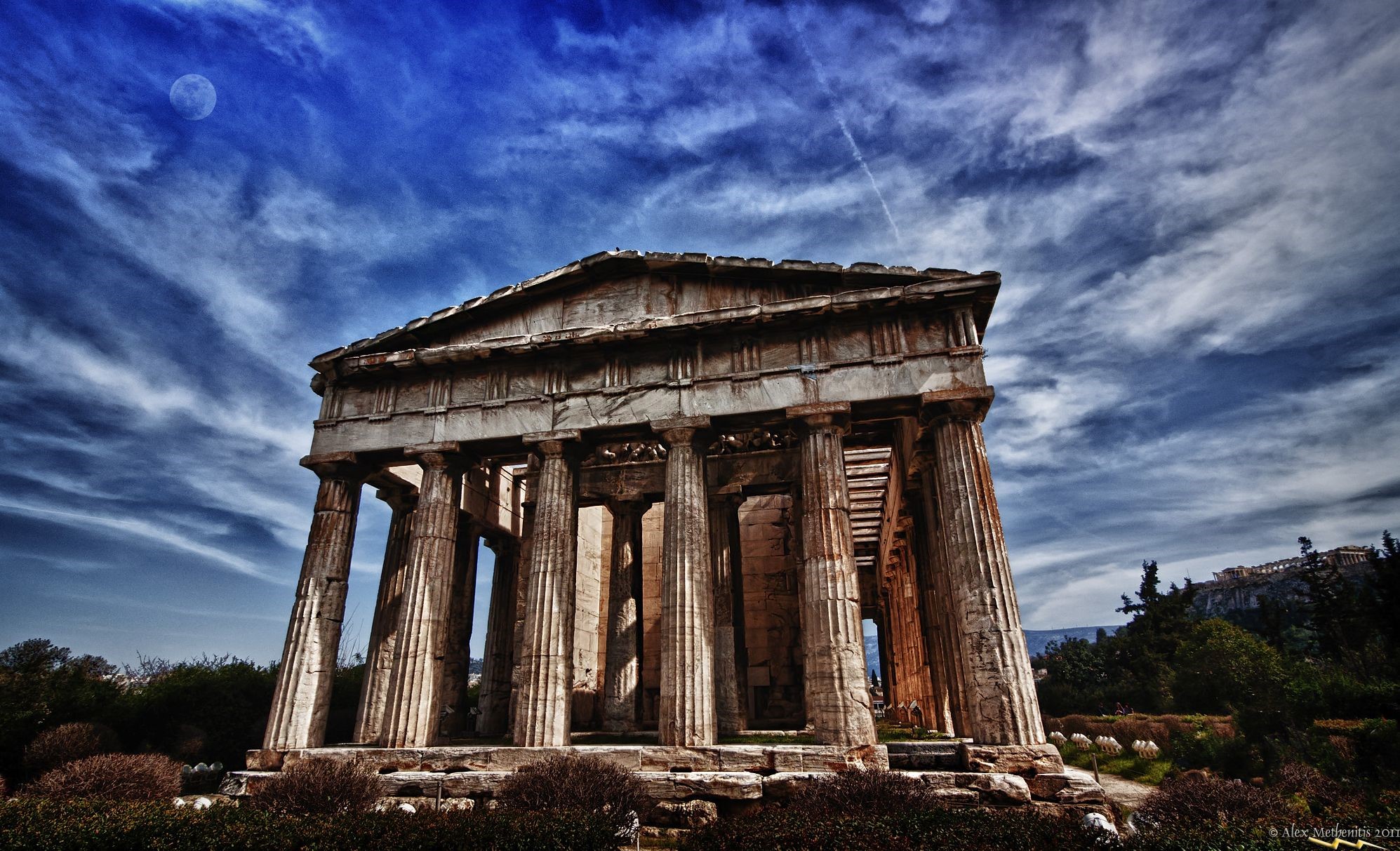 Ancient Greek Temple Ruins Under a Dramatic Sky HD Wallpaper