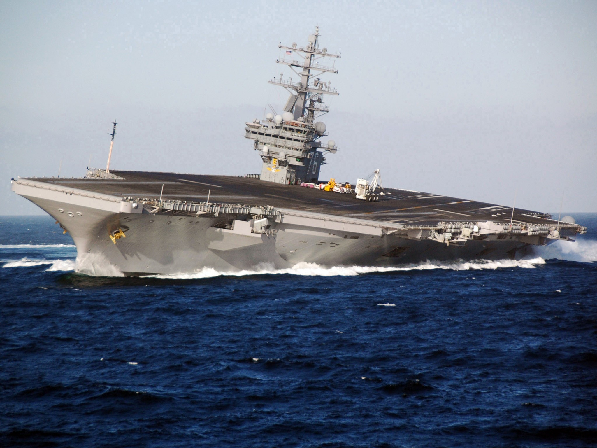 Aircraft carrier sailing on the ocean HD Wallpaper