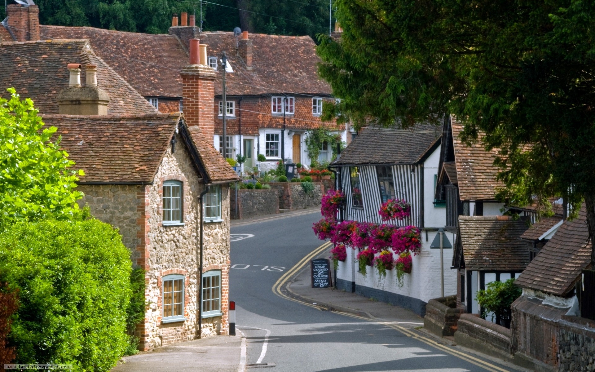 Village street with traditional houses in the United Kingdom HD Wallpaper