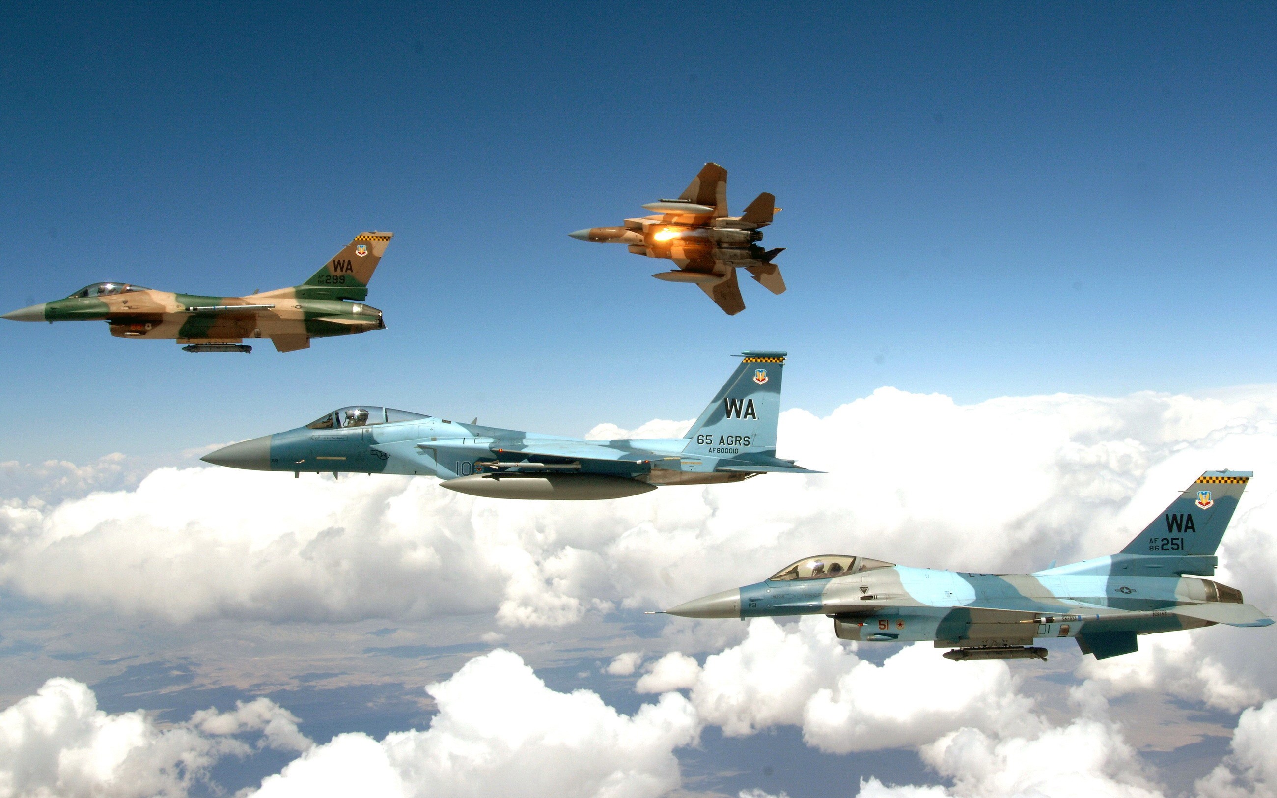 Four fighter jets flying in formation over clouds HD Wallpaper