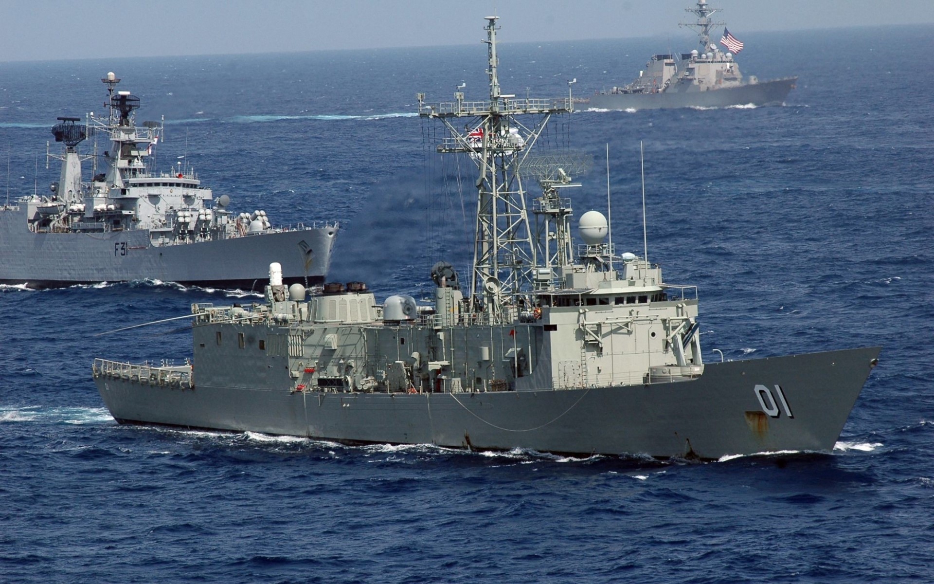 Three naval ships sailing on the ocean HD Wallpaper