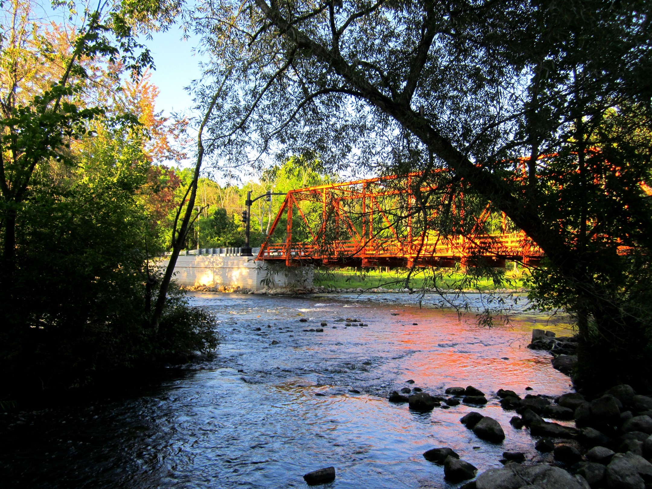 Orange bridge over Huron River with trees HD Wallpaper