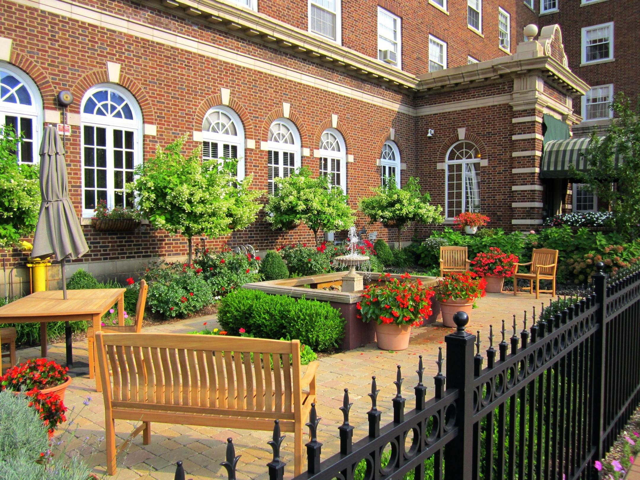 Courtyard with brick building and garden HD Wallpaper