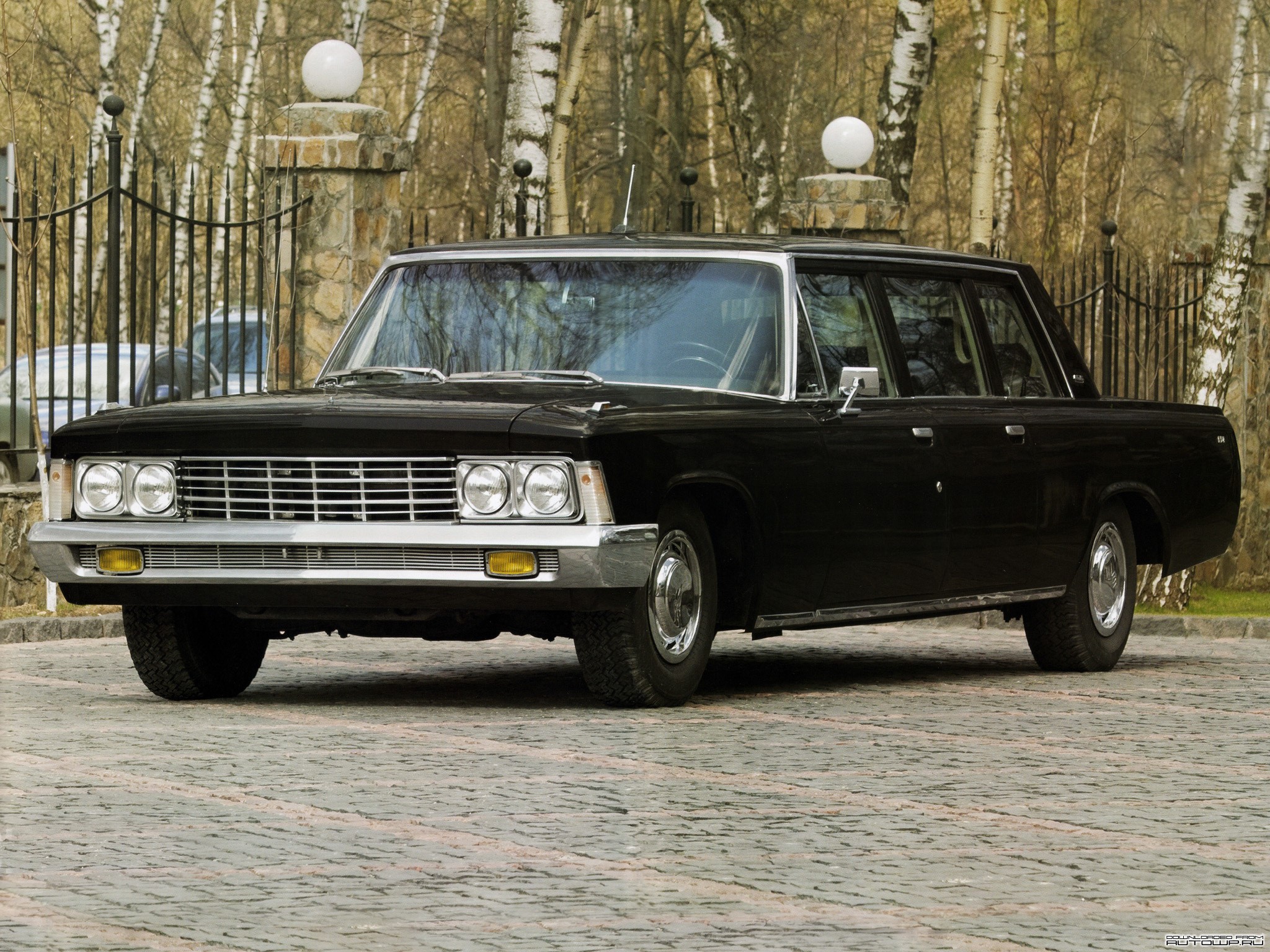 Black GAZ-13 Chaika limousine parked on cobblestone HD Wallpaper