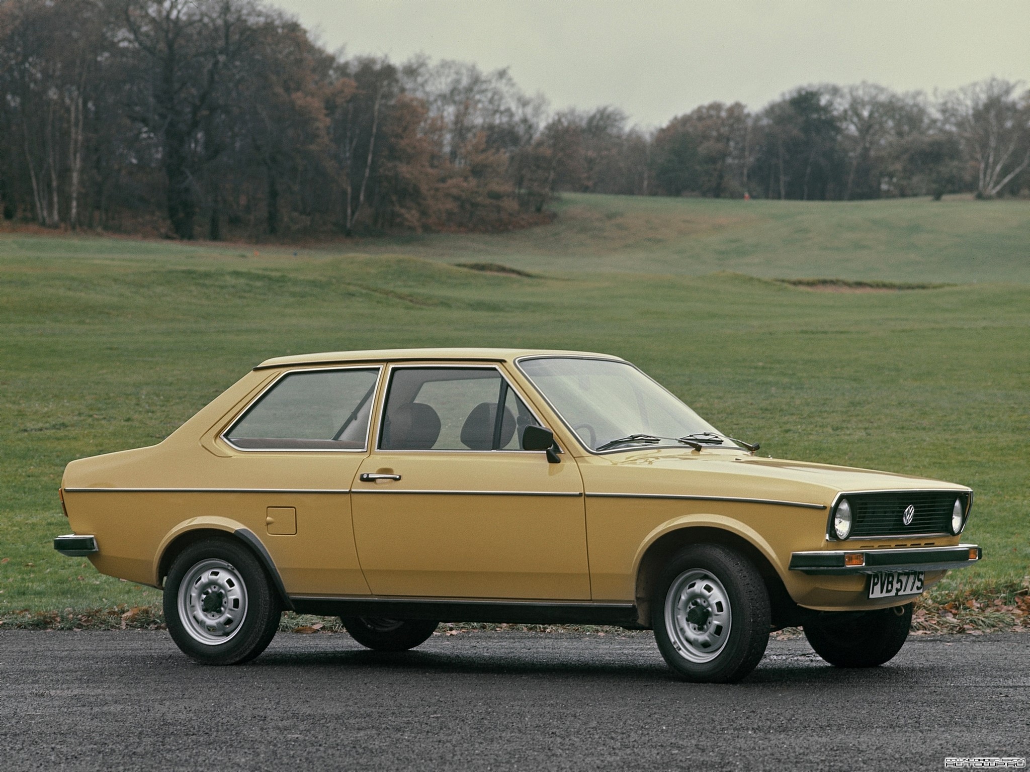 Yellow Volkswagen Polo parked on a road HD Wallpaper