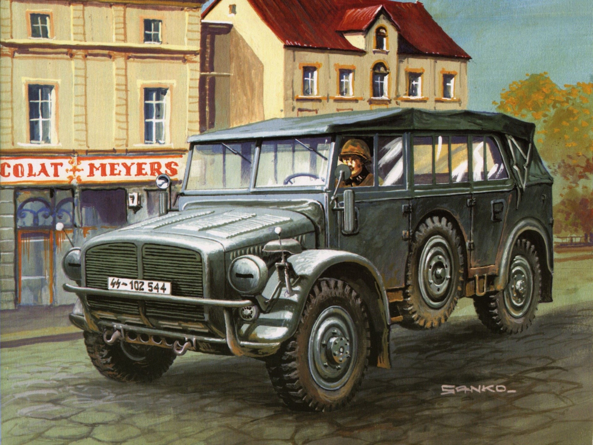 German military vehicle with driver in front of buildings HD Wallpaper