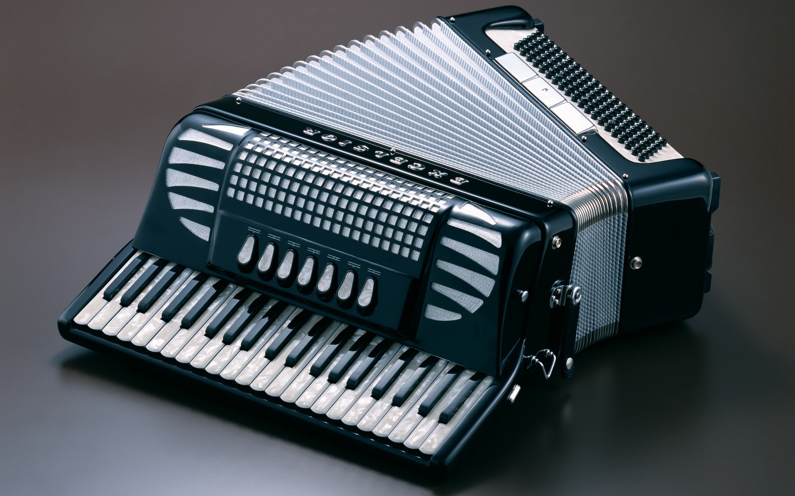 Black accordion with piano keys and bellows HD Wallpaper