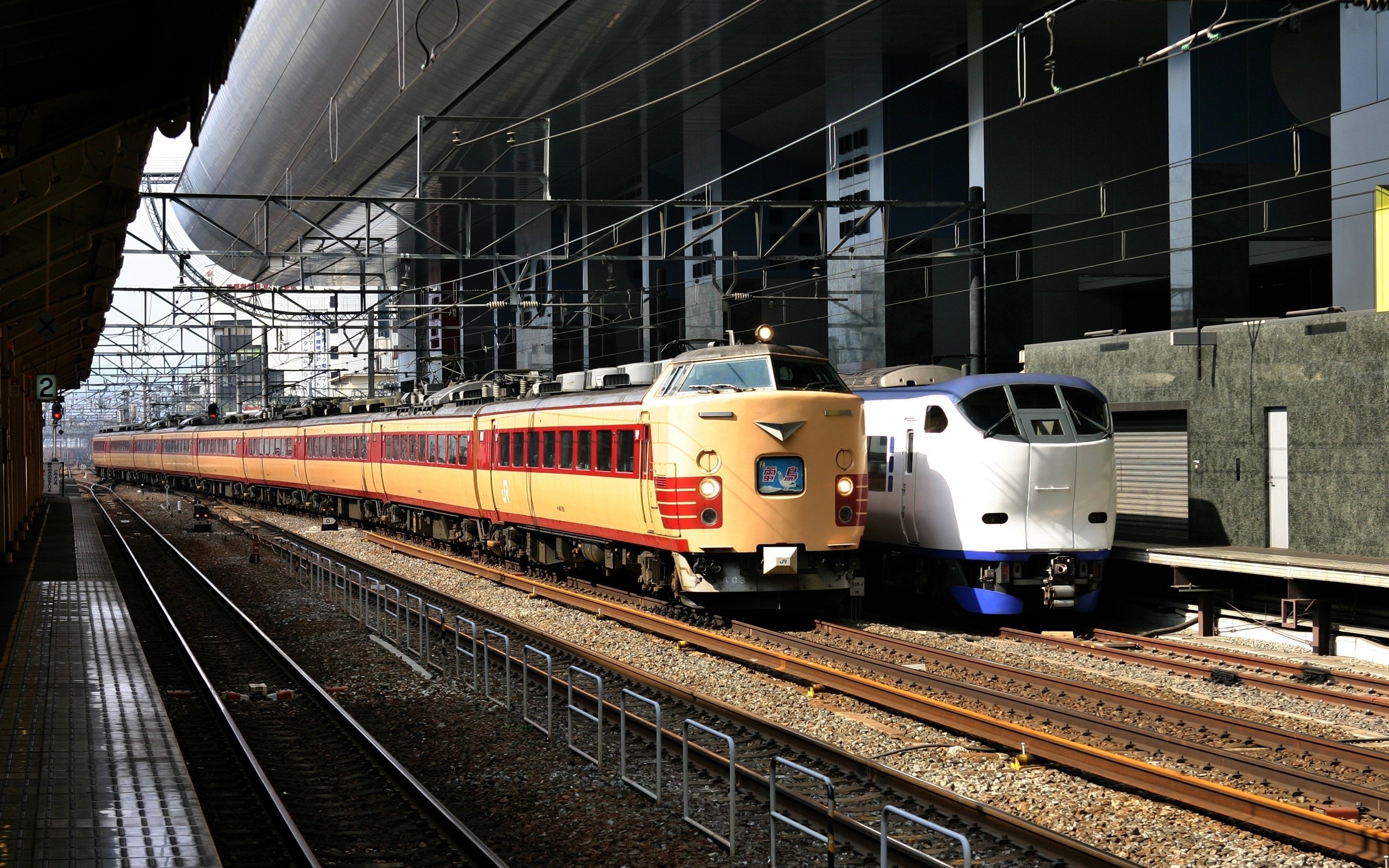 Two trains at a station platform HD Wallpaper