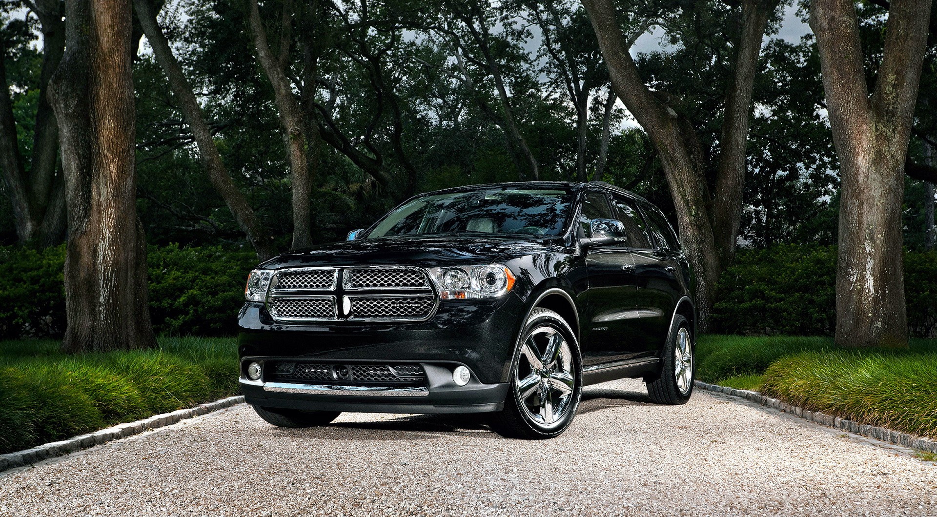 Black Dodge Durango parked on a gravel driveway HD Wallpaper
