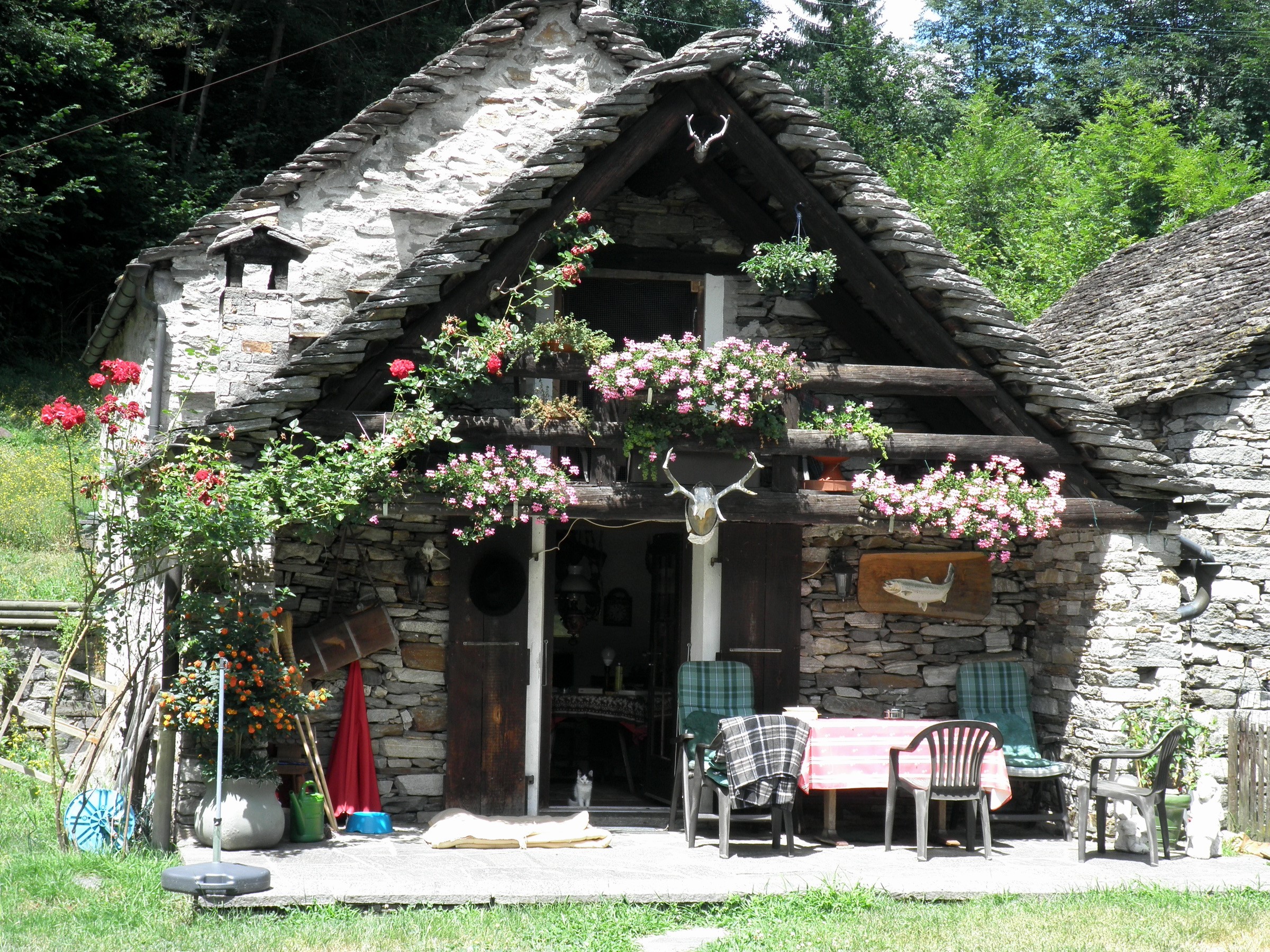 Stone house with flowers in Ticino, Switzerland HD Wallpaper