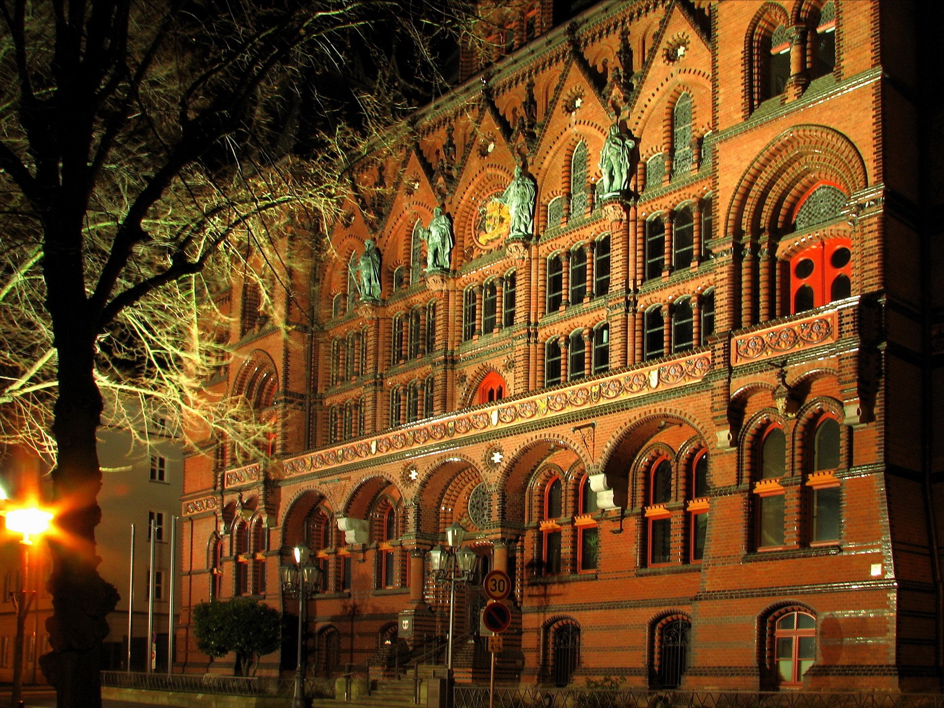 Brick building with arched windows at night in Germany HD Wallpaper