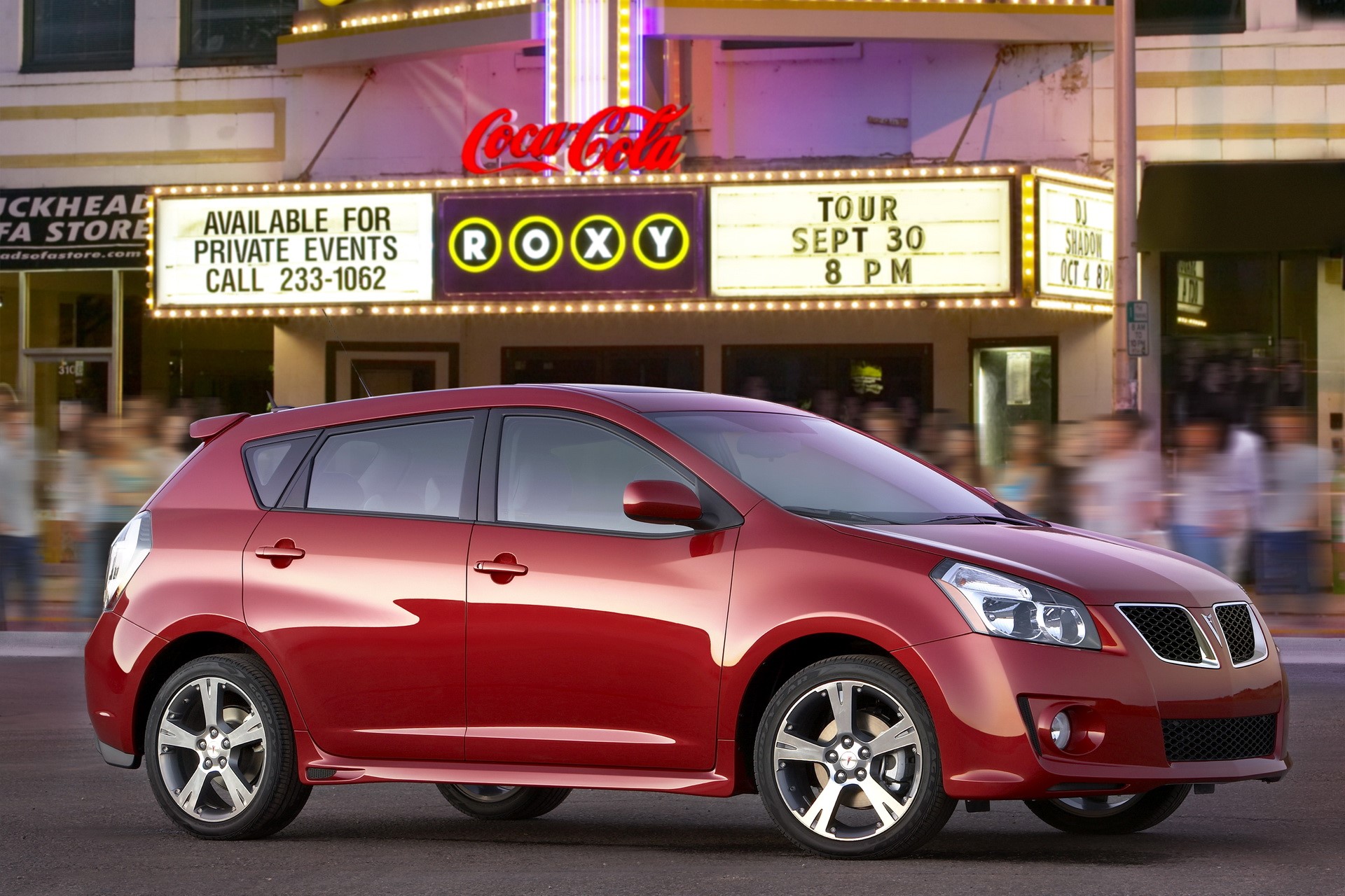 Red Pontiac Vibe in front of Roxy Theater HD Wallpaper