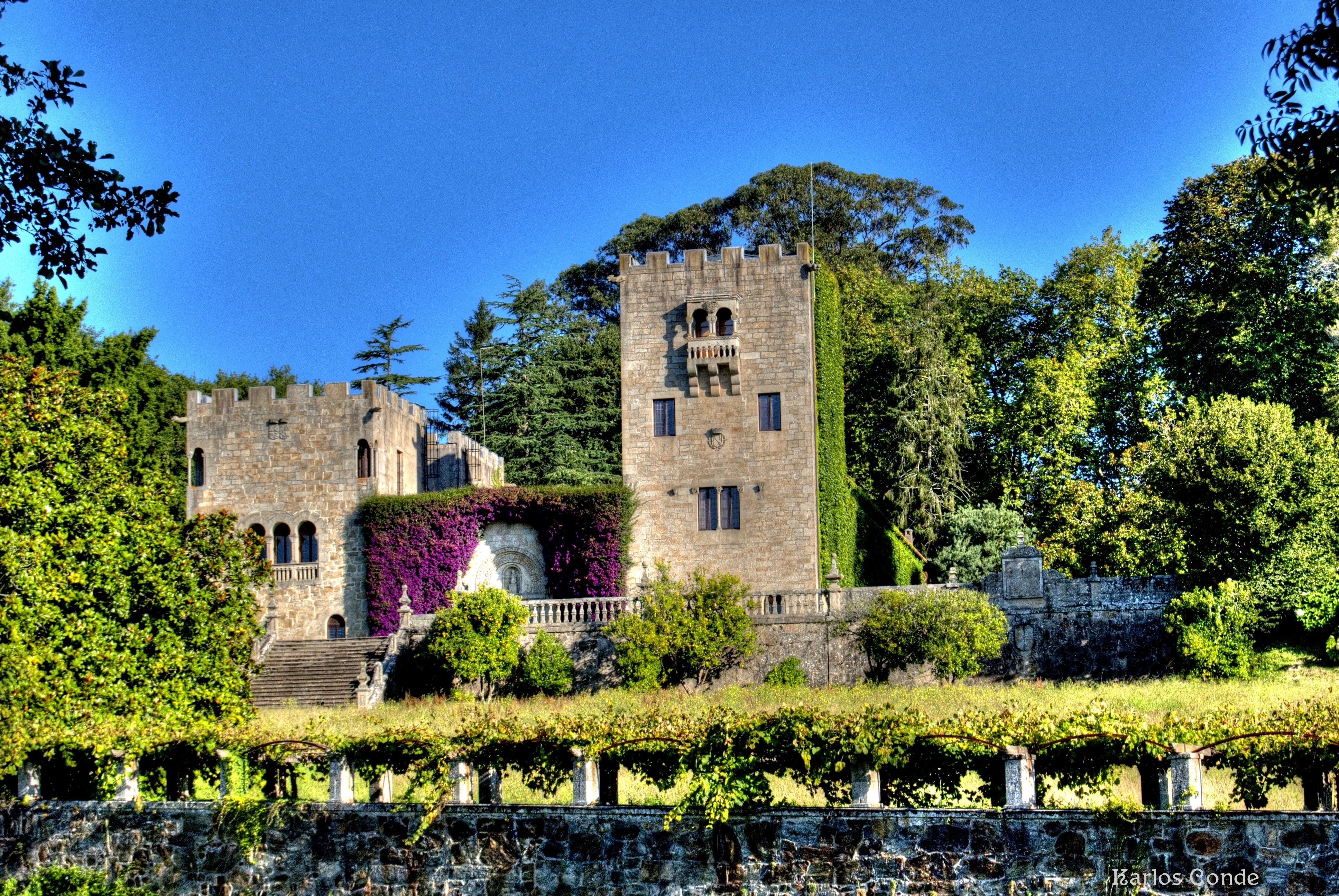 Castle surrounded by trees and flowers in Spain HD Wallpaper