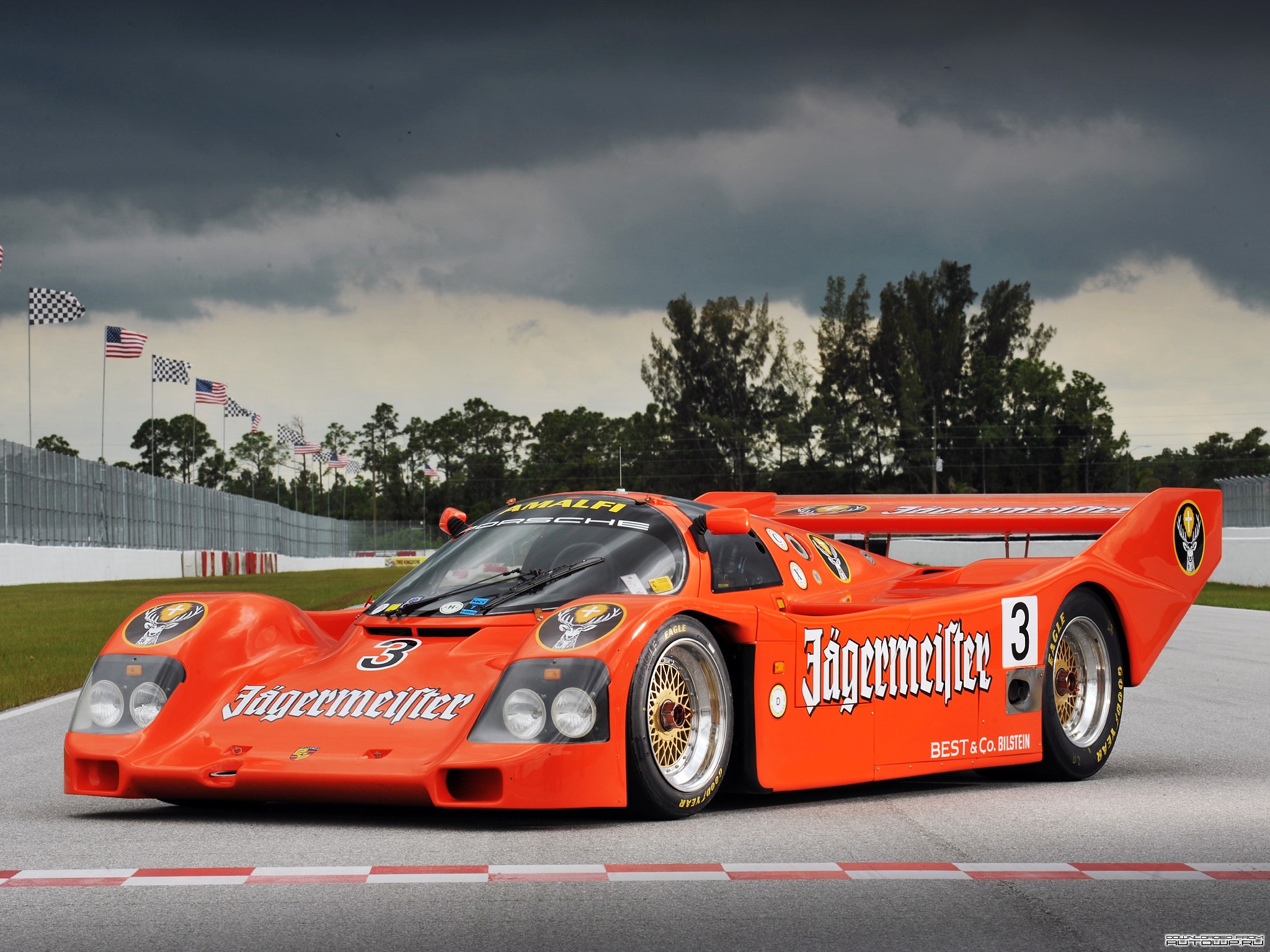 Orange Jägermeister Porsche 962C race car on track HD Wallpaper