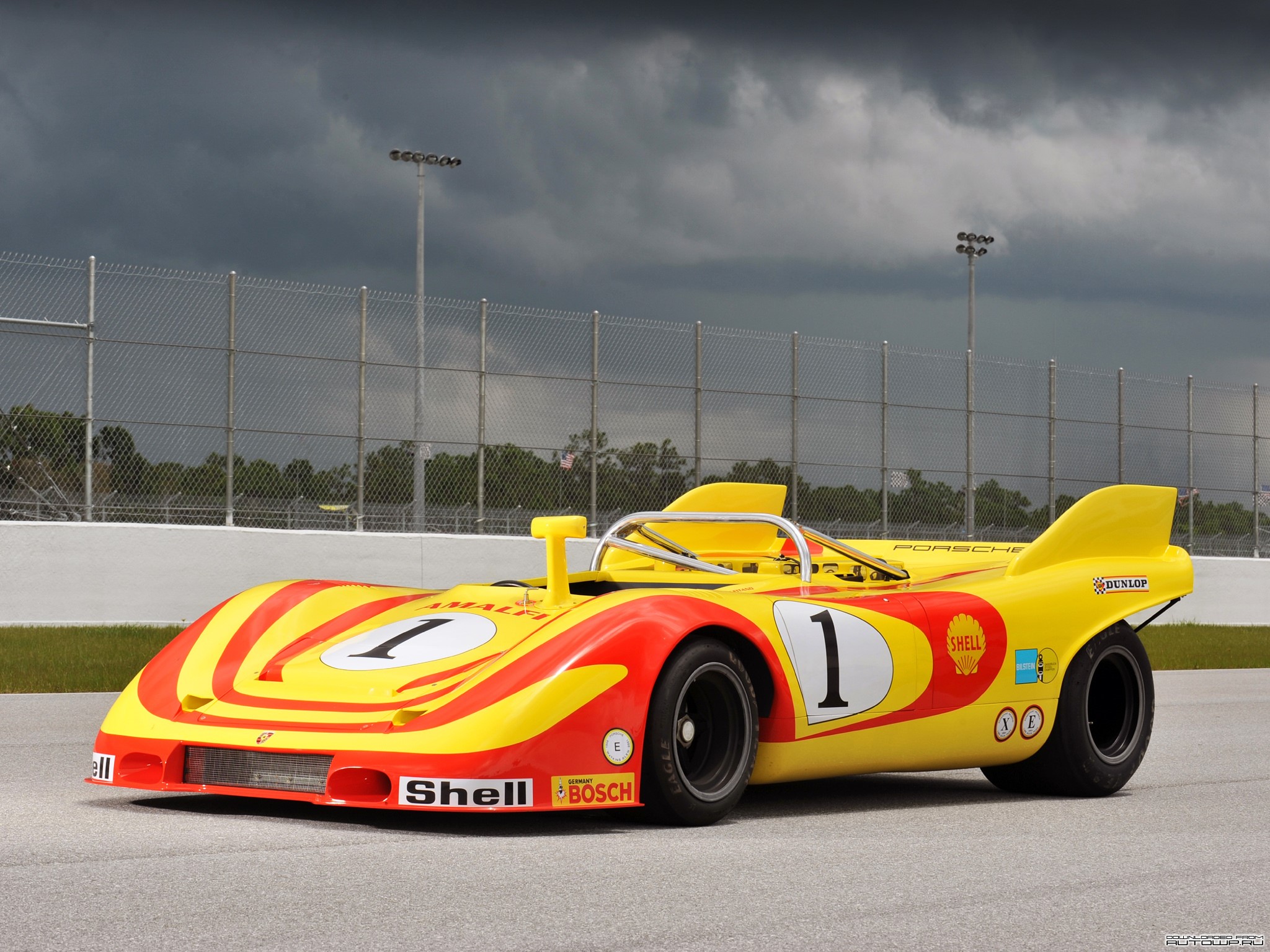 Yellow and red Porsche race car with number 1 HD Wallpaper